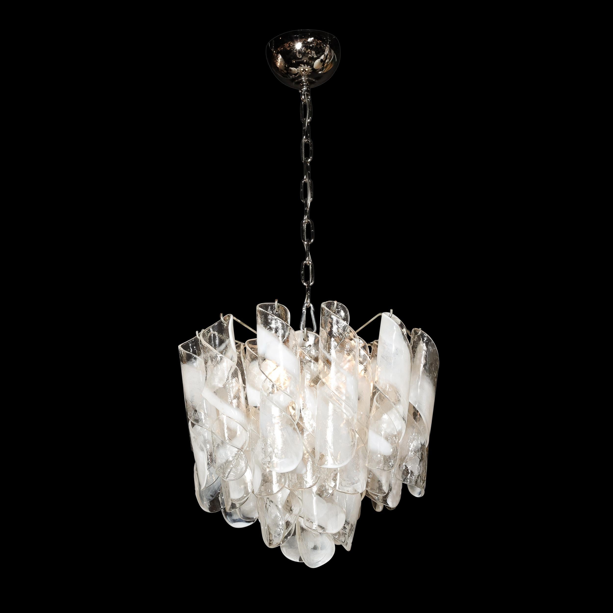 This highly elegant and dynamic Mid-Century Modernist Hand-Blown Murano Glass Torciglioni Chandelier is by Mazzega and originates from Italy, Circa 1970. A well proportioned and excellent quality fixture, this piece features Hand-Blown 