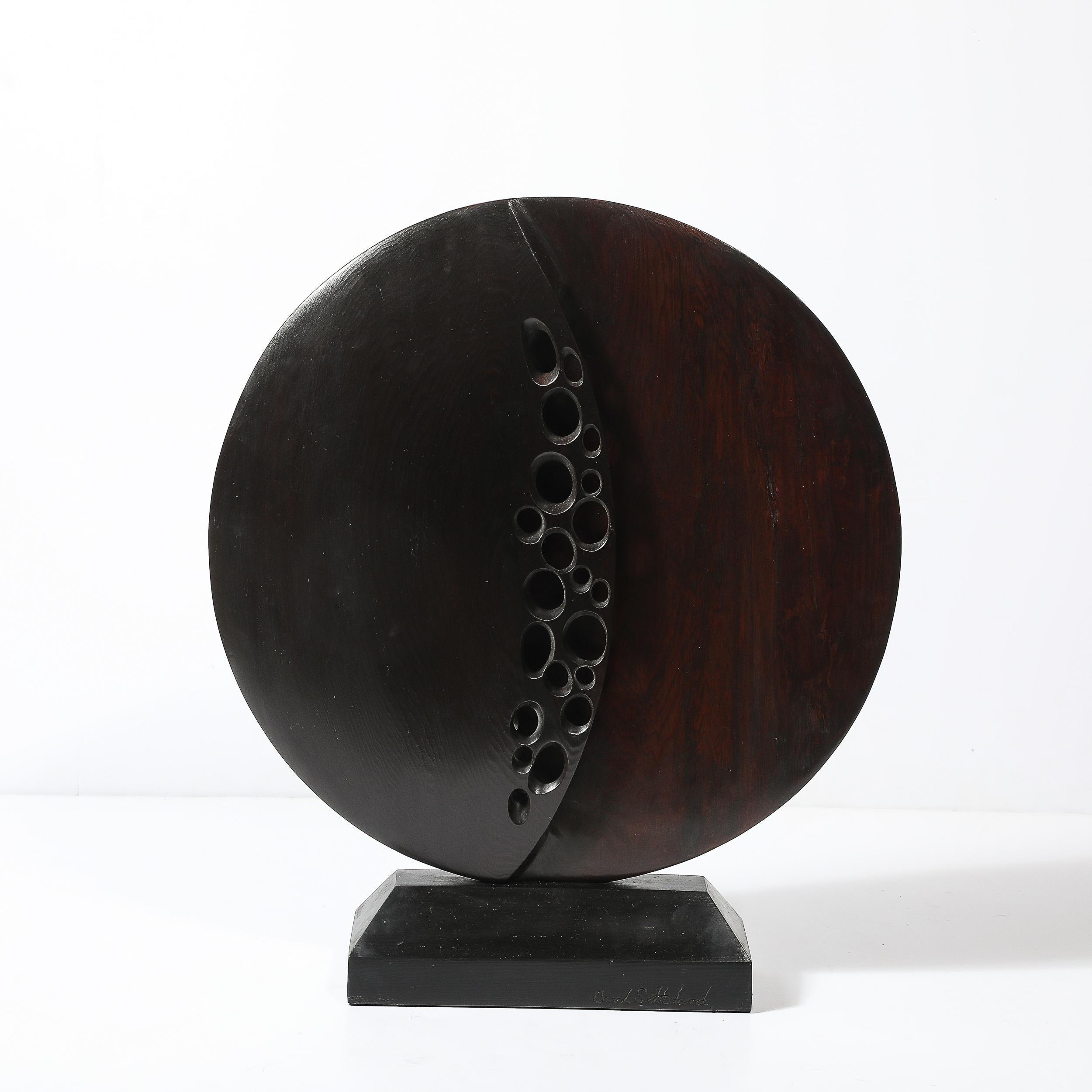 Signed by Carol Setterlund, this sculpture reflects the artist's dedication to form and texture, embodying the essence of mid-century artistry. The natural curves and flowing lines of the sculpture make it an ideal addition to various decor styles,