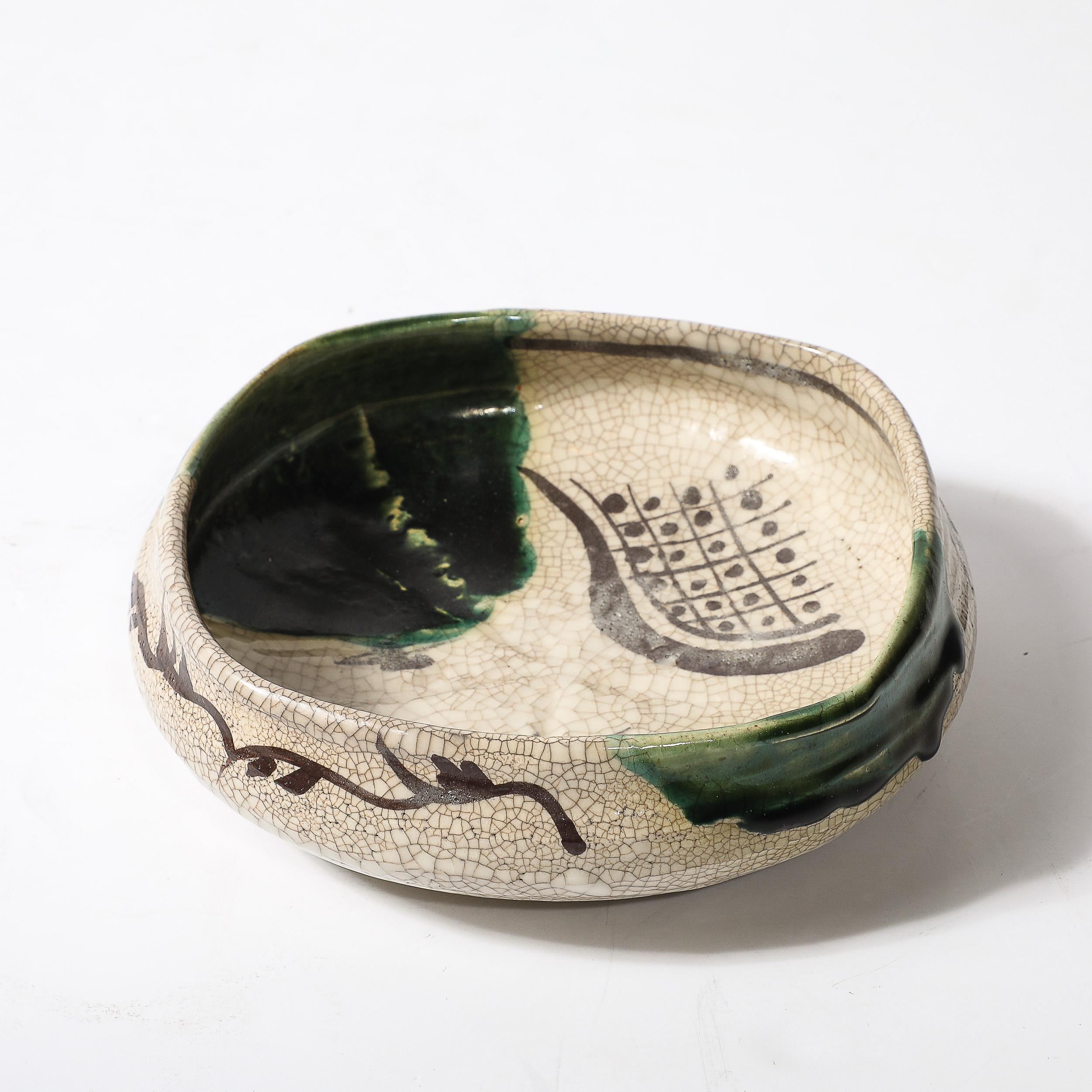 This exquisite Mid-Century Modernist Oribe bowl, crafted in Japan during the 20th century, is a stunning example of the enduring beauty and craftsmanship of Japanese ceramics. The bowl features a distinctive green glaze, characteristic of Oribe