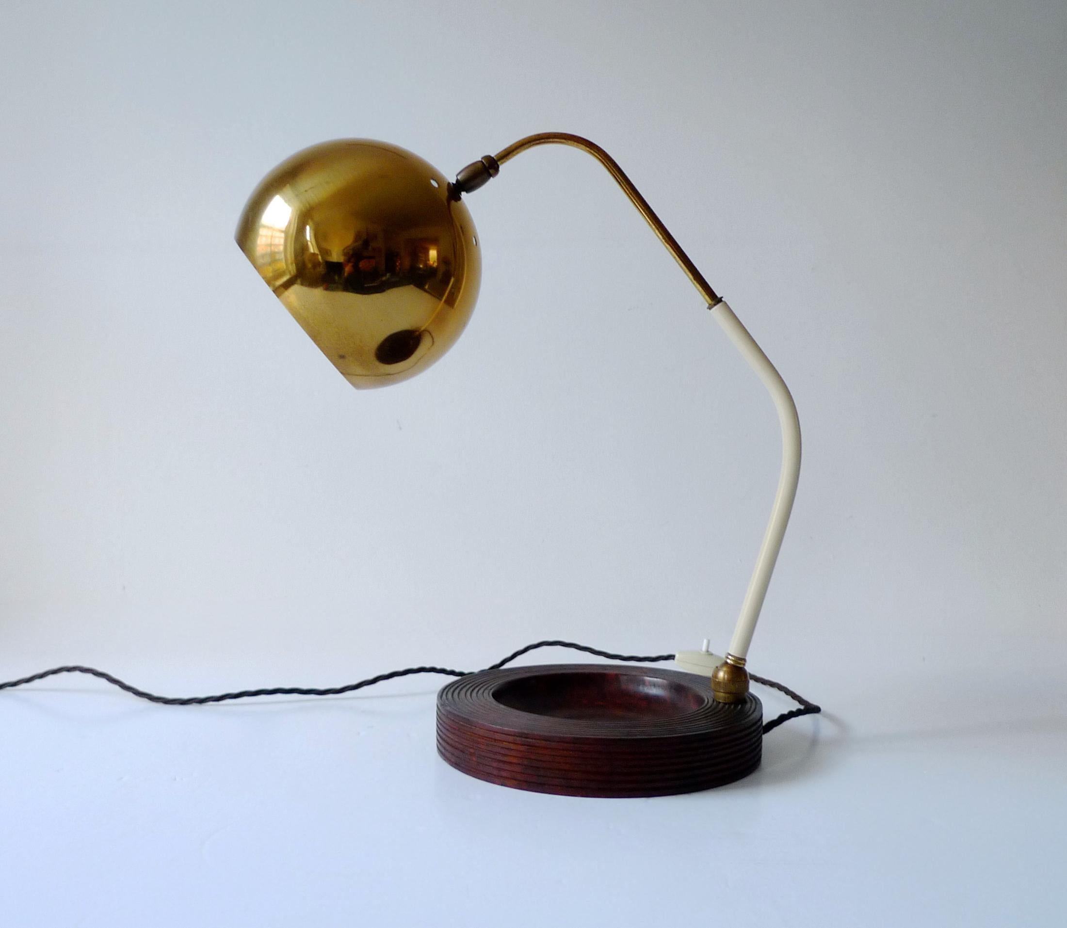 An extremely elegant Italian Mid-Century Modernist 'eyeball' table lamp, dating from circa 1950s and consisting of a brass shade and upper stem, white enamelled lower stem and a turned Burl wood base. 

The lamp has been rewired with a brown