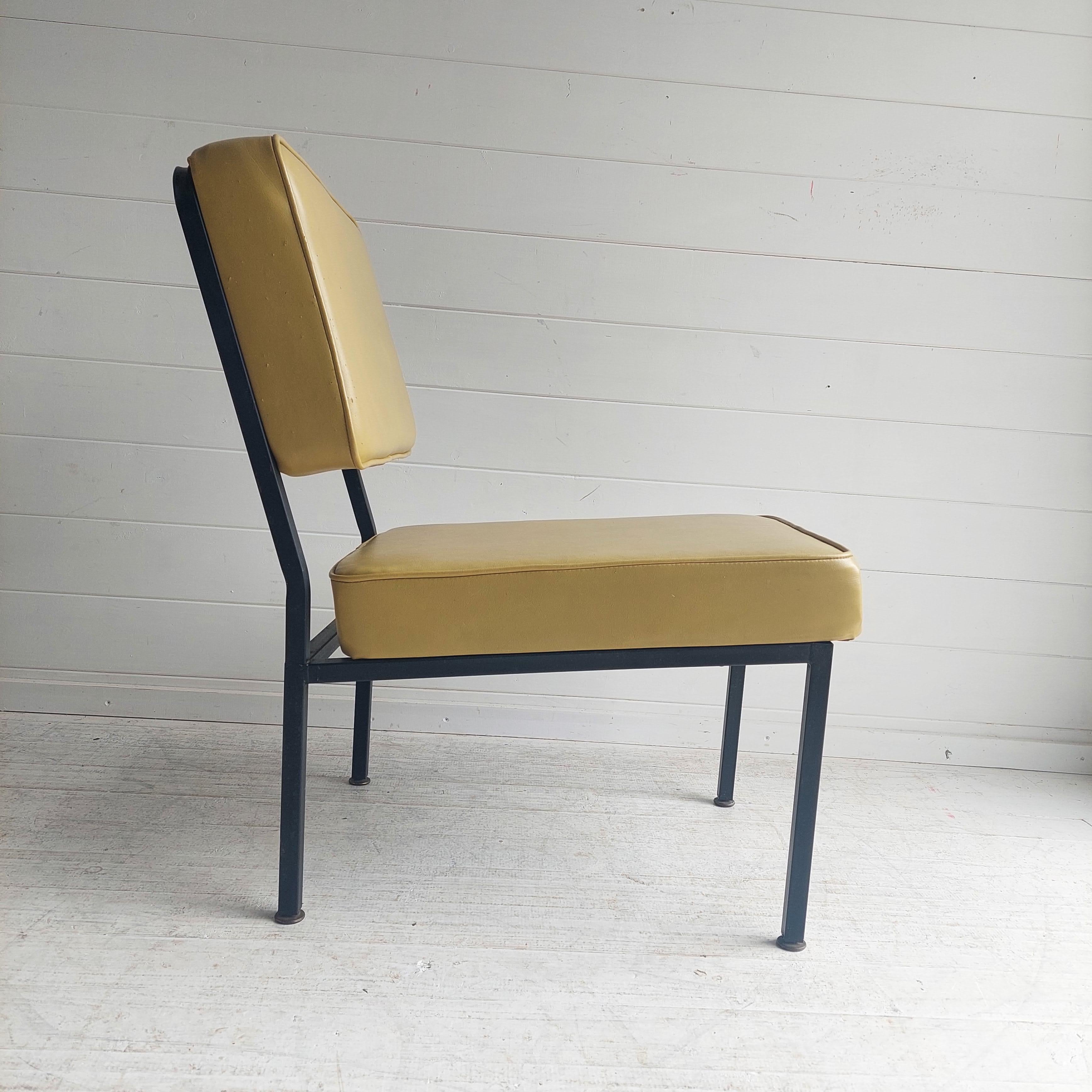 Armchair in the manner of Pierre Guariche 1926-1995. 

Remarkable by the inclination of the backrest and the advance of the seat ensuring comfort and aestheticism.
Seat and backrest dressed in olive green leatherette in the spirit of the 50s. 
Metal