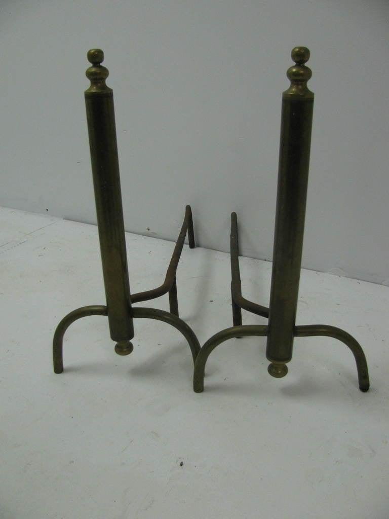 Fabulous hand machined, tall, and statuesque brass andirons in the Bauhaus style. Brass has mellowed and retained an even patina. Well proportioned. In excellent antique condition with minimal wear. Please check out all of our other Andirons as we