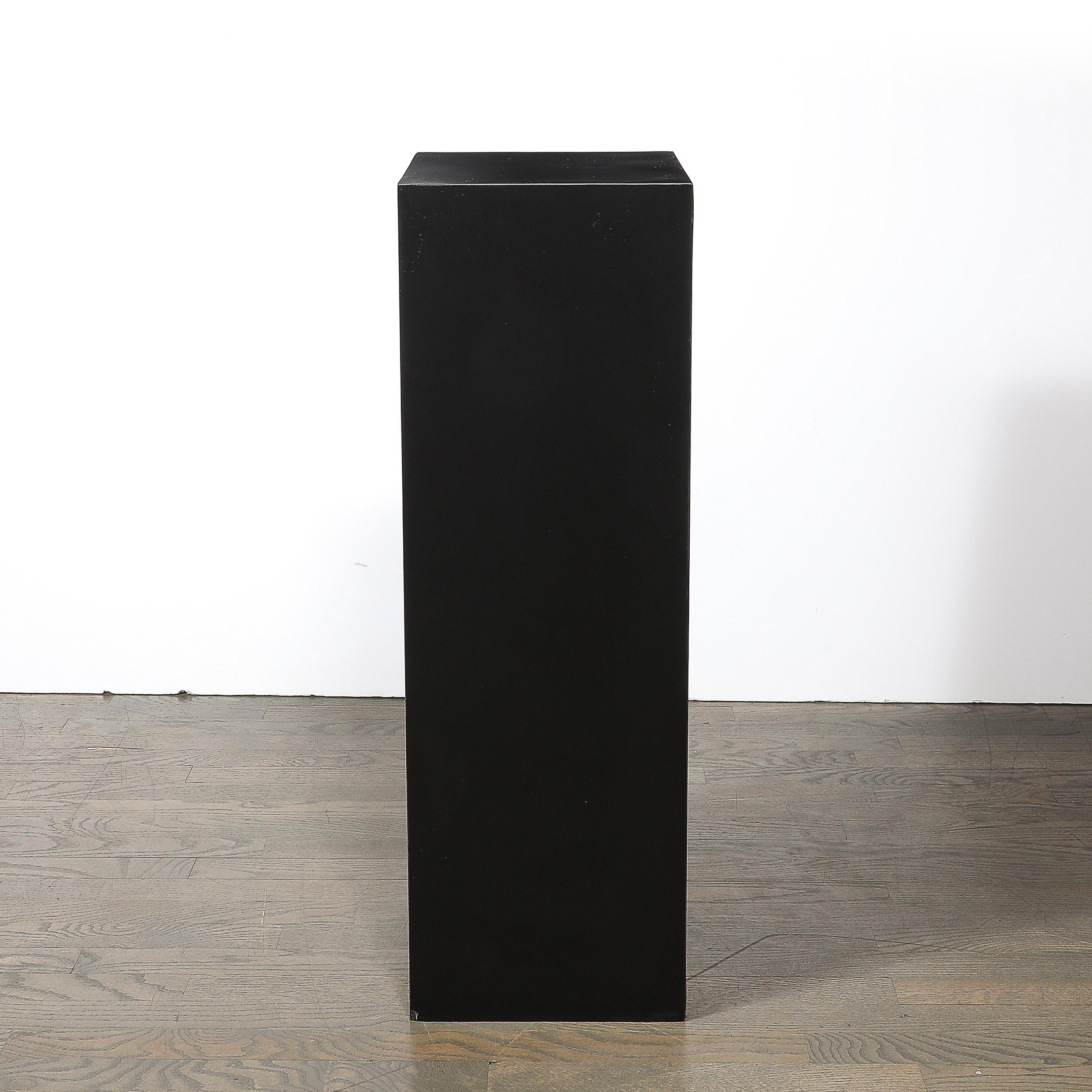This sleek mid-century modern pedestal exemplifies minimalist design and versatility. Crafted in the 20th century, the matte black laminate finish offers a refined yet understated aesthetic, ideal for complementing modern interiors.

Perfect for