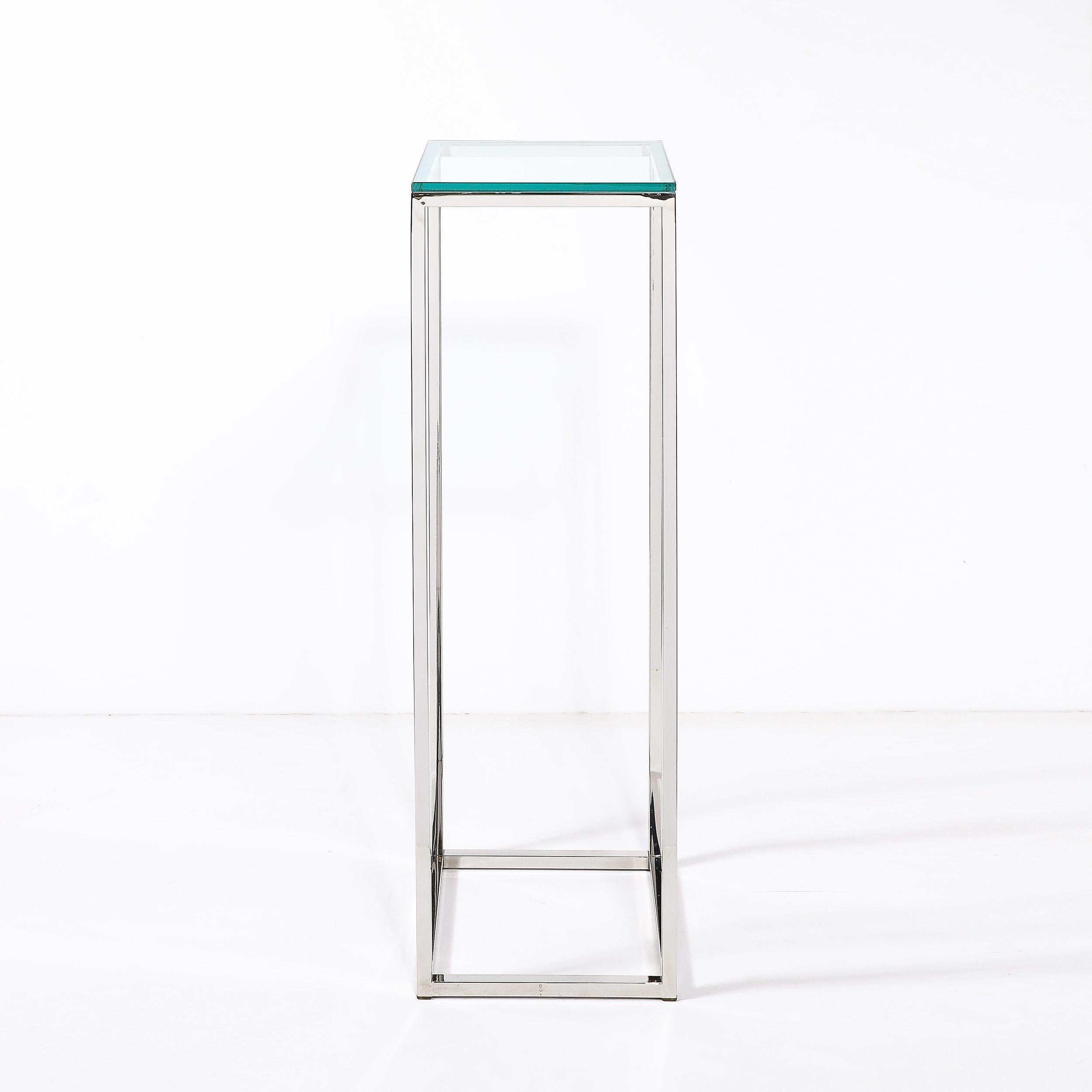 Ce piédestal rectiligne minimal et épuré de style moderniste du milieu du siècle, en chrome, avec plateau en verre, provient des États-Unis, vers 1970. Il se caractérise par une construction minimale en poutres rectangulaires étroites en chrome