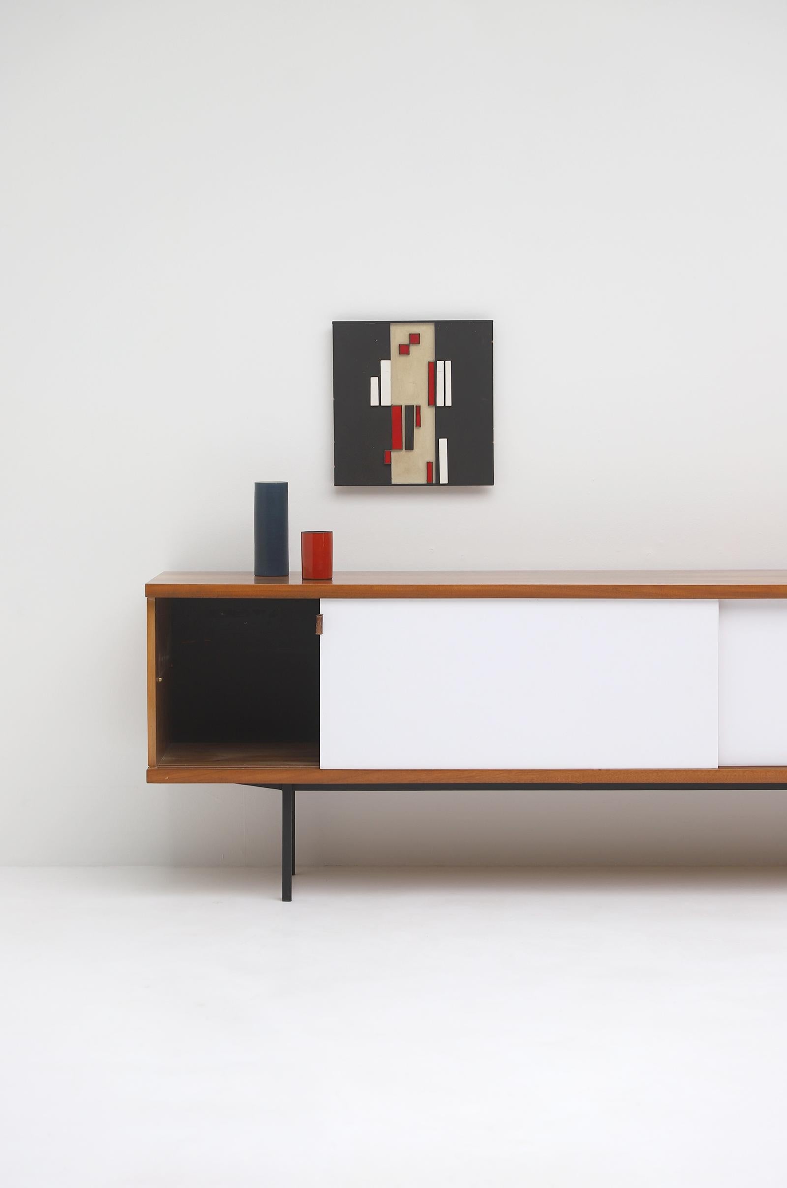 Stunning sideboard designed by Jos De Mey, made by Luxus Kortrijk in the 1950s. De Meys designs of this period are more exclusive and hard to find. This sideboard is made in a nice patterned wood fished with white formica. It has 4 outside drawers