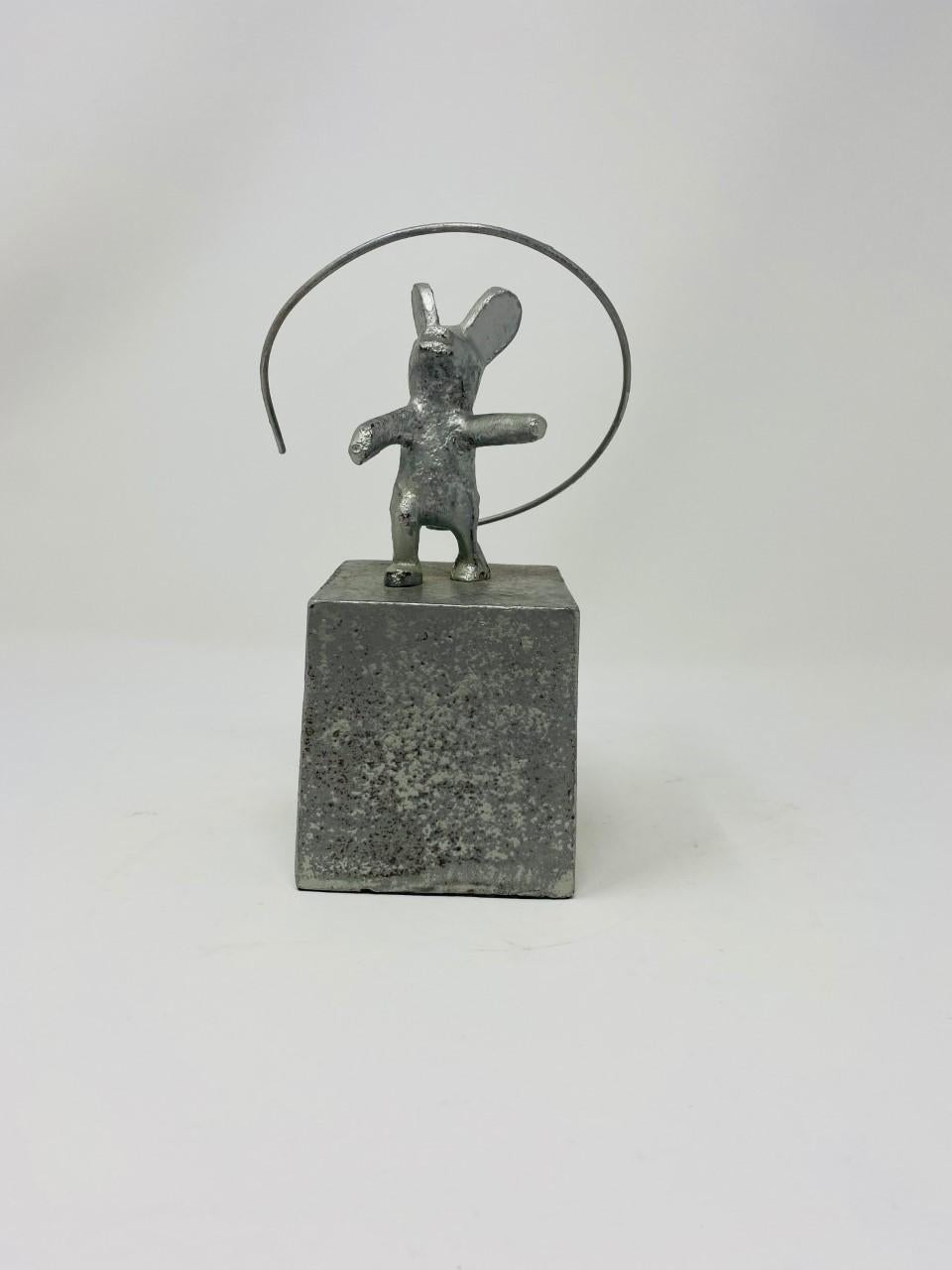 Beautiful modernist mouse sculpture. A piece that is full of whimsy and detail. Clean lines are the base for this piece as a mouse figure orbits on its own tail. Beautiful, enchanting and dynamic. Cast iron with zinc finish. Clean lines with a