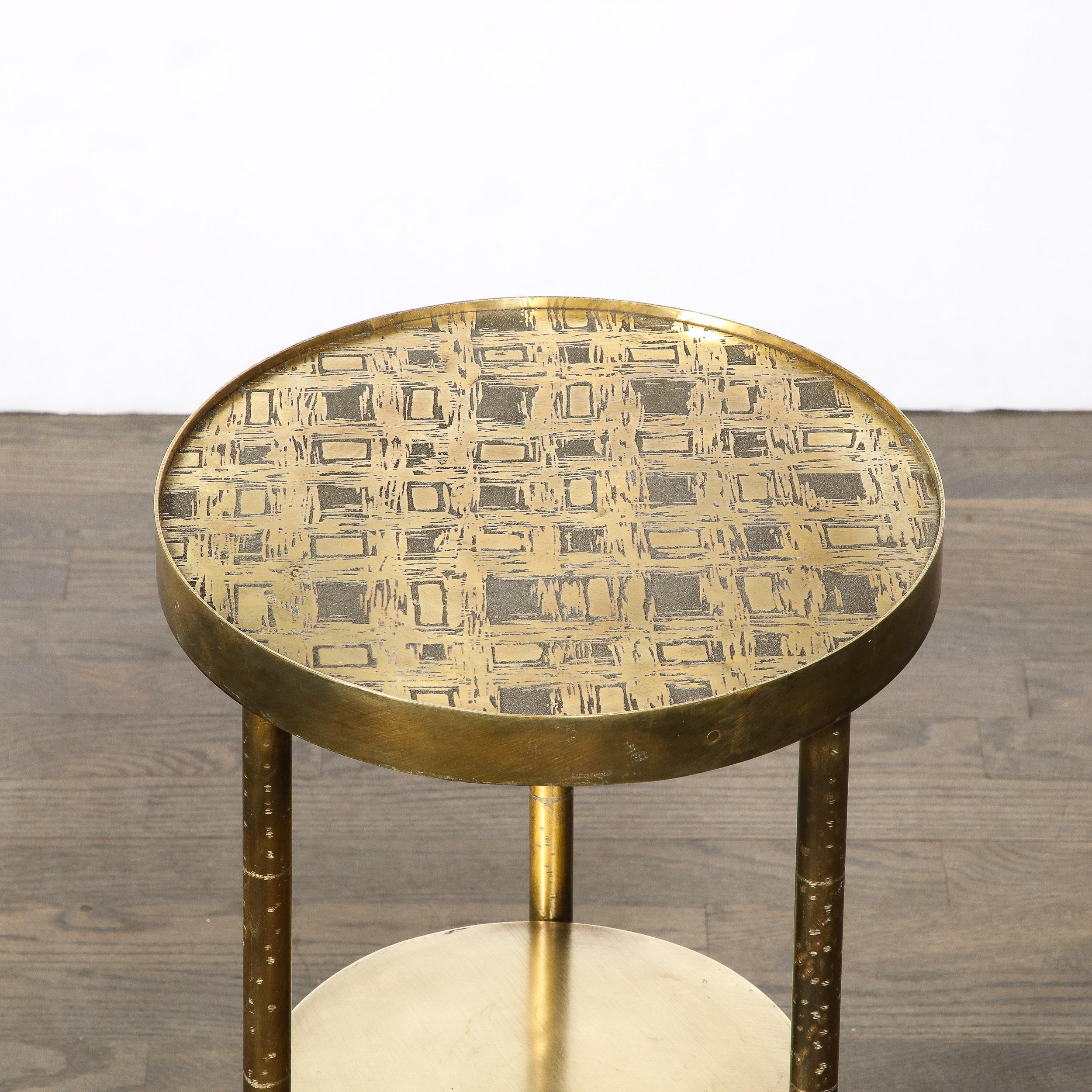 This beautiful and refined Mid-Century Modern end table was realized by the esteemed Philip Laverne in the United States circa 1960. It features two circular tiers and three legs all in patinated bronze. The top of the table offers an organic