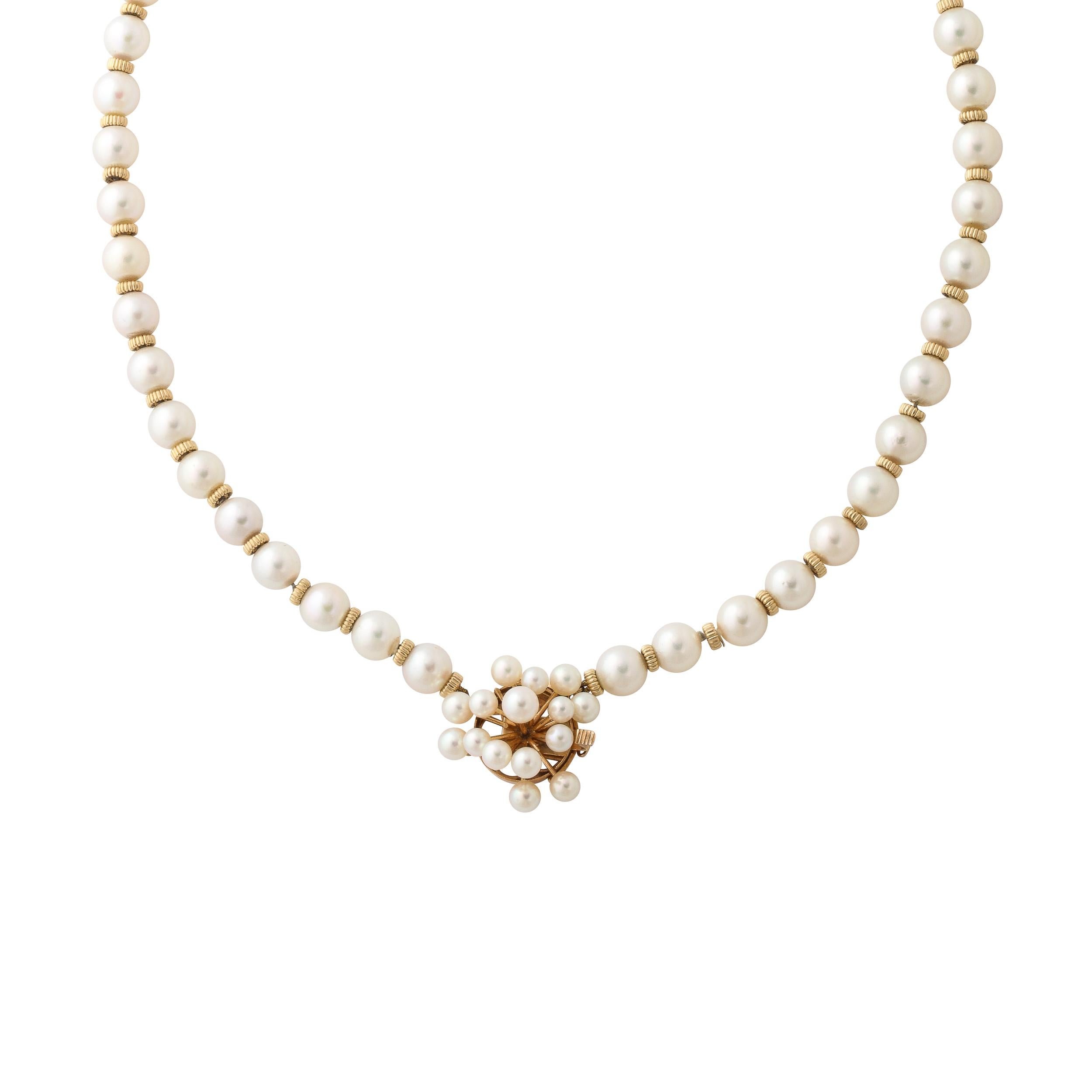 This Mid -Century Modernist pearl and 14k gold necklace is fitted with approximately 7mm pearls with a ribbed 14k gold spacer between each pearl and finished with a sputnik form clasp in 14k yellow gold set with 14 pearls . The clasp is marked 14k