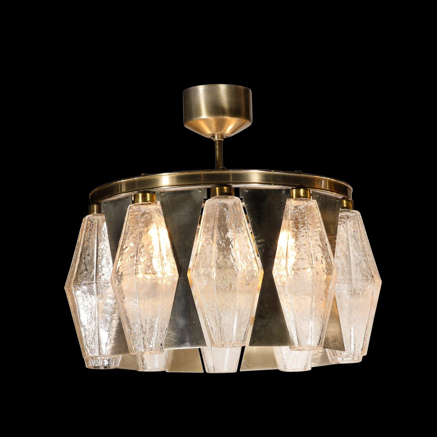 This stunning Mid-Century Modern chandelier was realized by the esteemed atelier of Venini in Murano, Italy- the island off the coast of Venice renowned for centuries for its superlative glass production- circa 1970. It features translucent