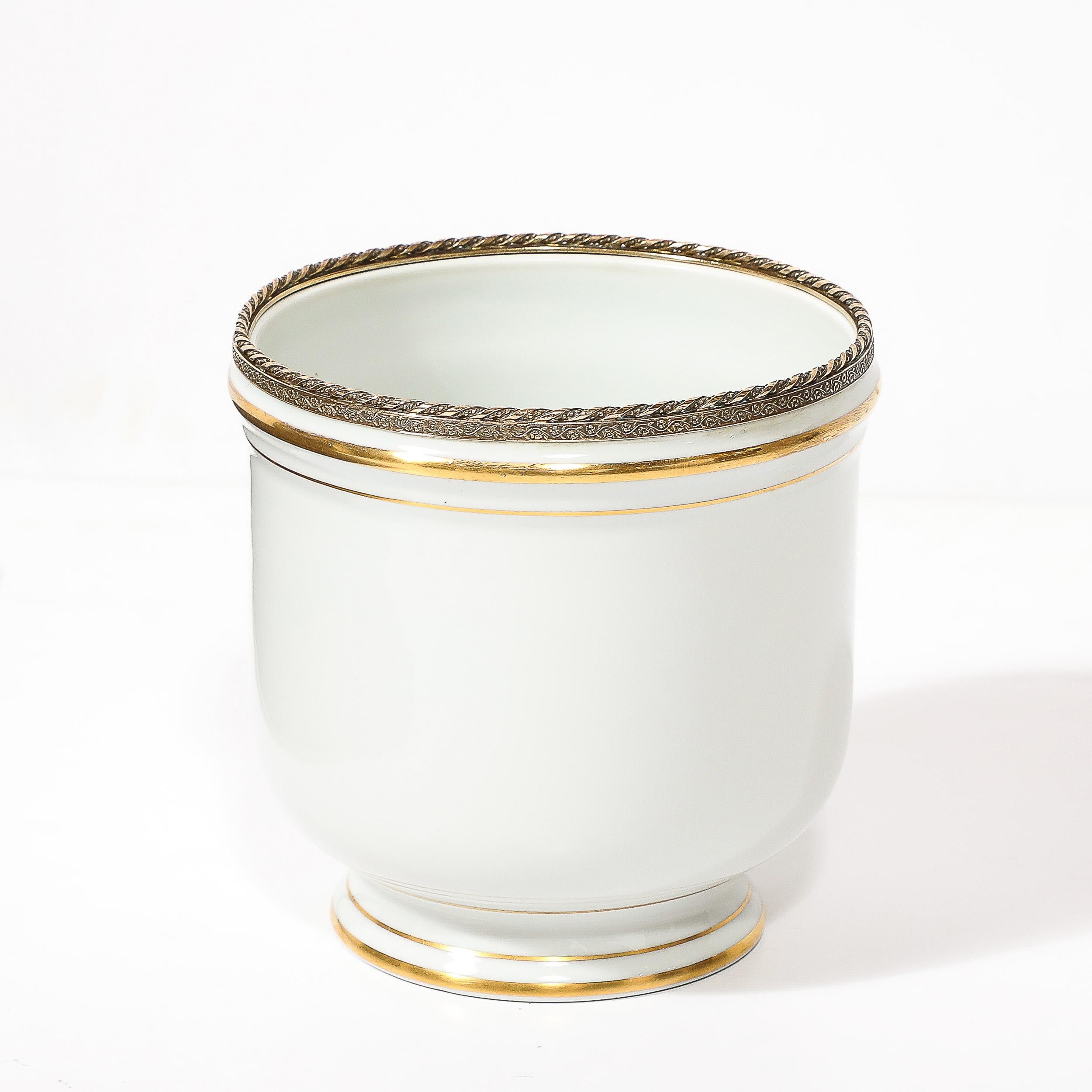 This elegant and beautifully scaled Mid-Century Modernist Porecelain Cachepot W/Gilt Detailing by Limoges originates from France, Circa 1950. This lovely cachepot features a classical tapered form with bands of gilt detailing circumscribing the body