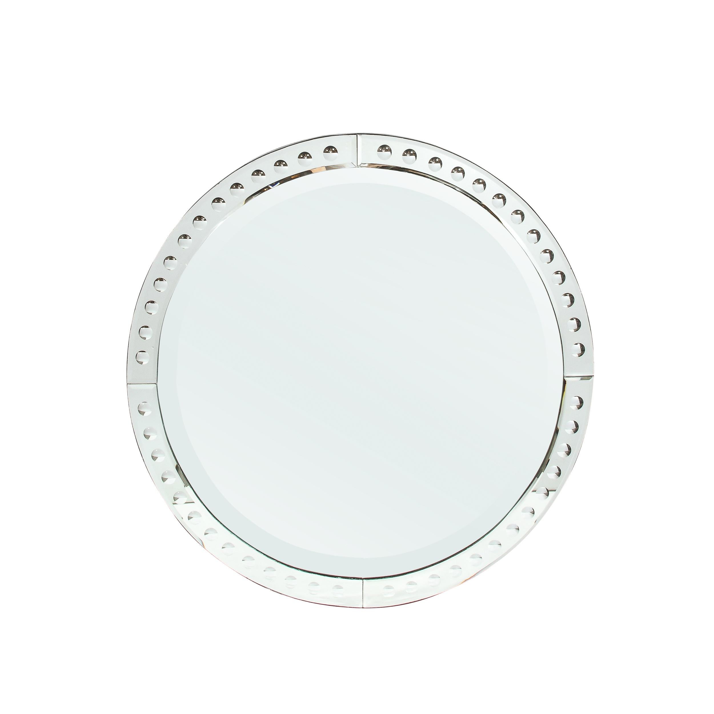 This sophisticated and minimal Mid-Century Modernist Round Mirror W/ Beveled Edge and Reversed Etched Detailing originates from France, Circa 1950. Minimal and beautifully proportioned, this mirror features a border composed of four panels of curved