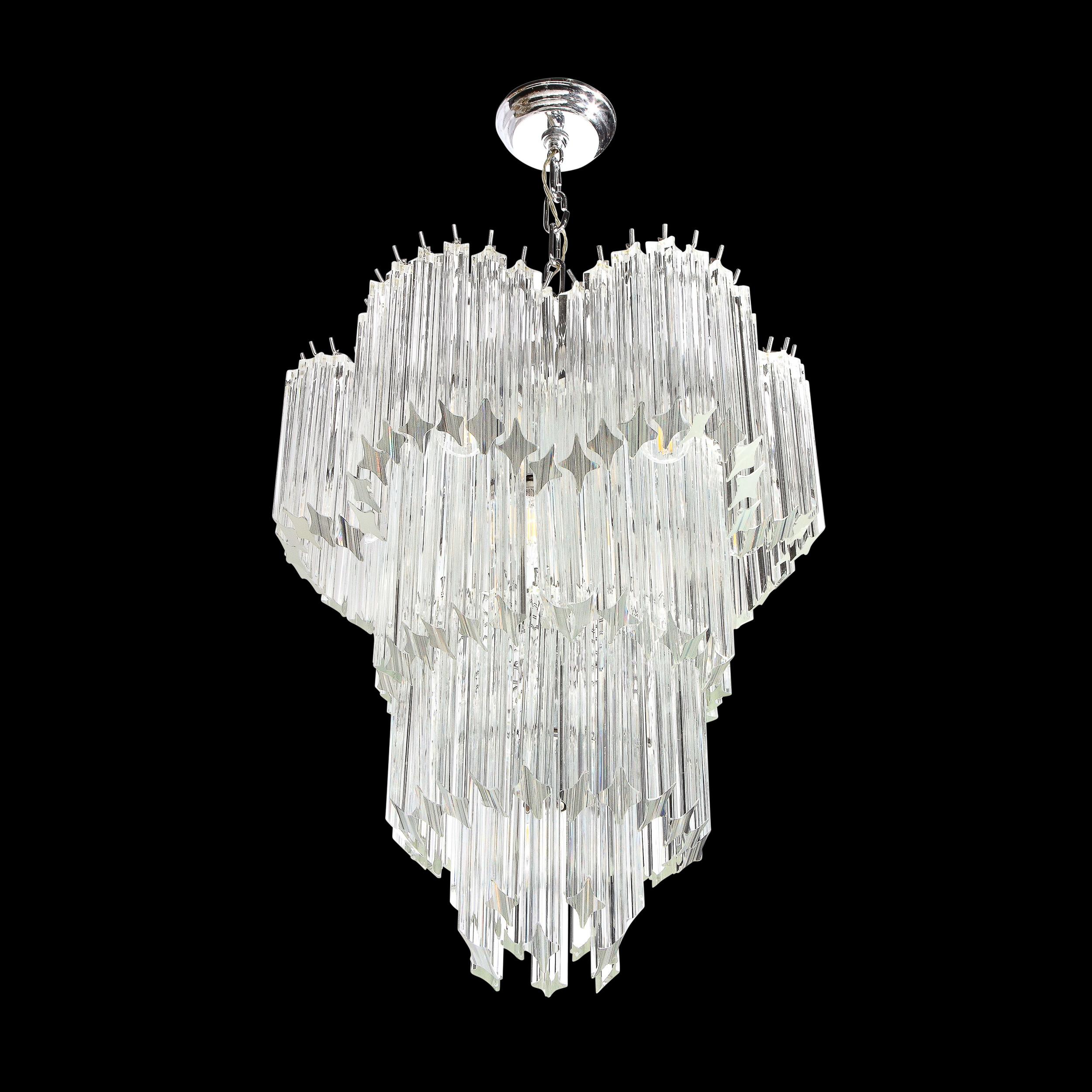 Mid-Century Modernist four-tier cut triedre crystal Camer chandelier. This chandelier features four-tiers of individually hung crystal triedre Camer rods. The top-tier features a scalloped designed border, giving the chandelier great dimension. The