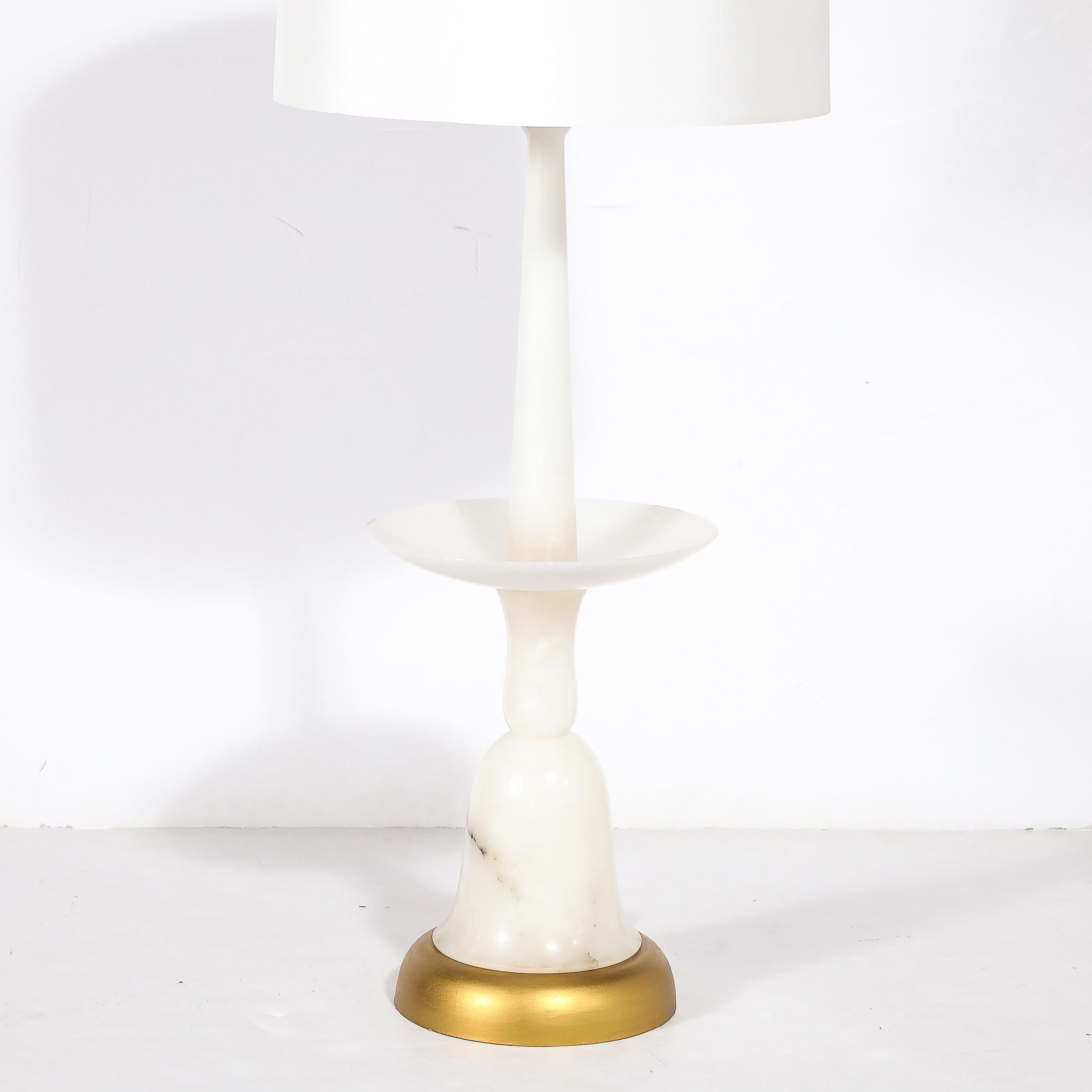 This unique and well proportioned Mid-Century Modernist Sculptural Balustrade Form Table Lamp in Carrera Marble W/ Gilt Base originates from Italy, Circa 1960. Features a lovely silhouette of elegantly curved lines and detailing composed of stacked