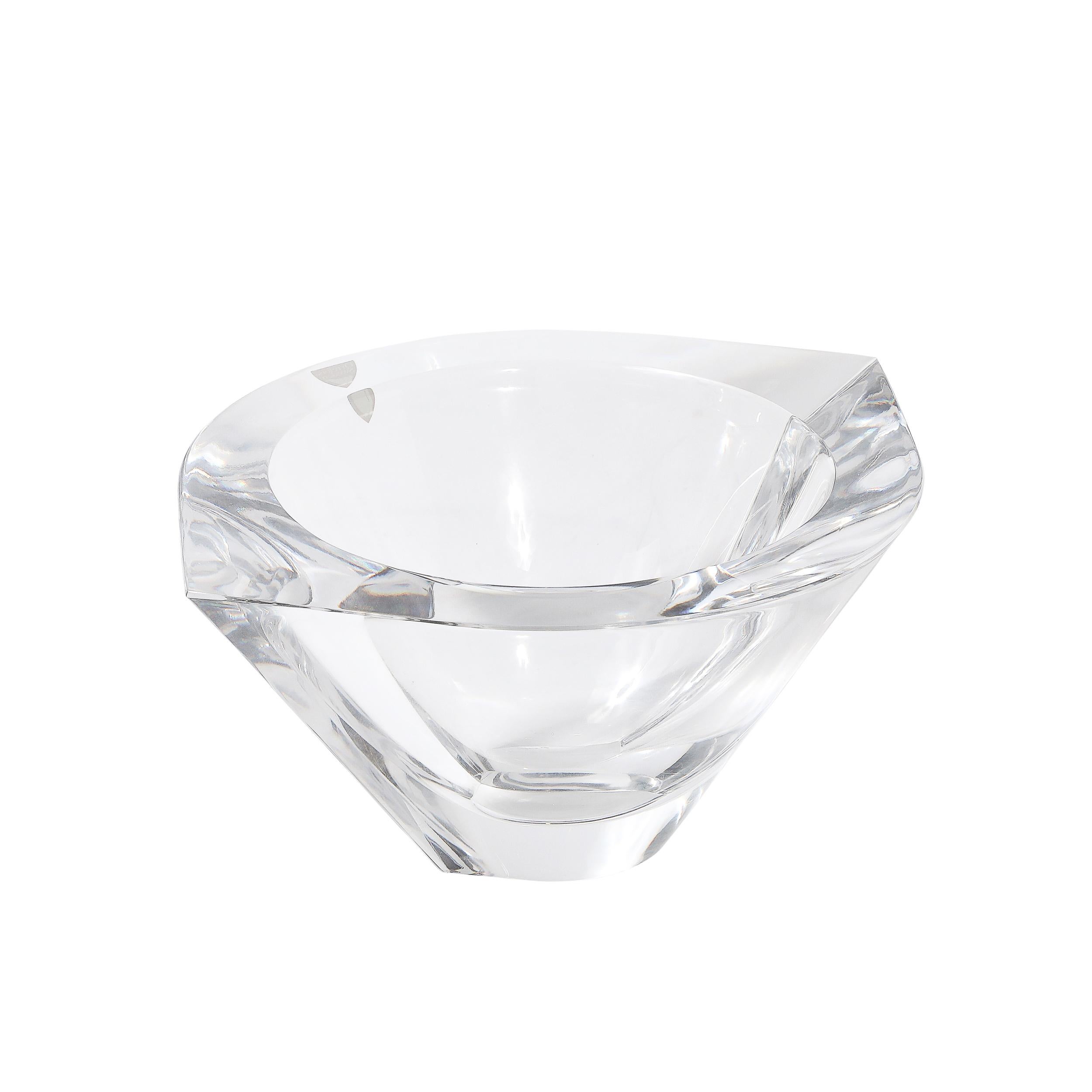 This elegant mid-century modernist crystal bowl, circa 1960, showcases the artistry of Orrefors, Sweden. The sculptural design beautifully captures and refracts light, highlighting the crystal's exceptional clarity.
Signed by Orrefors, the bowl