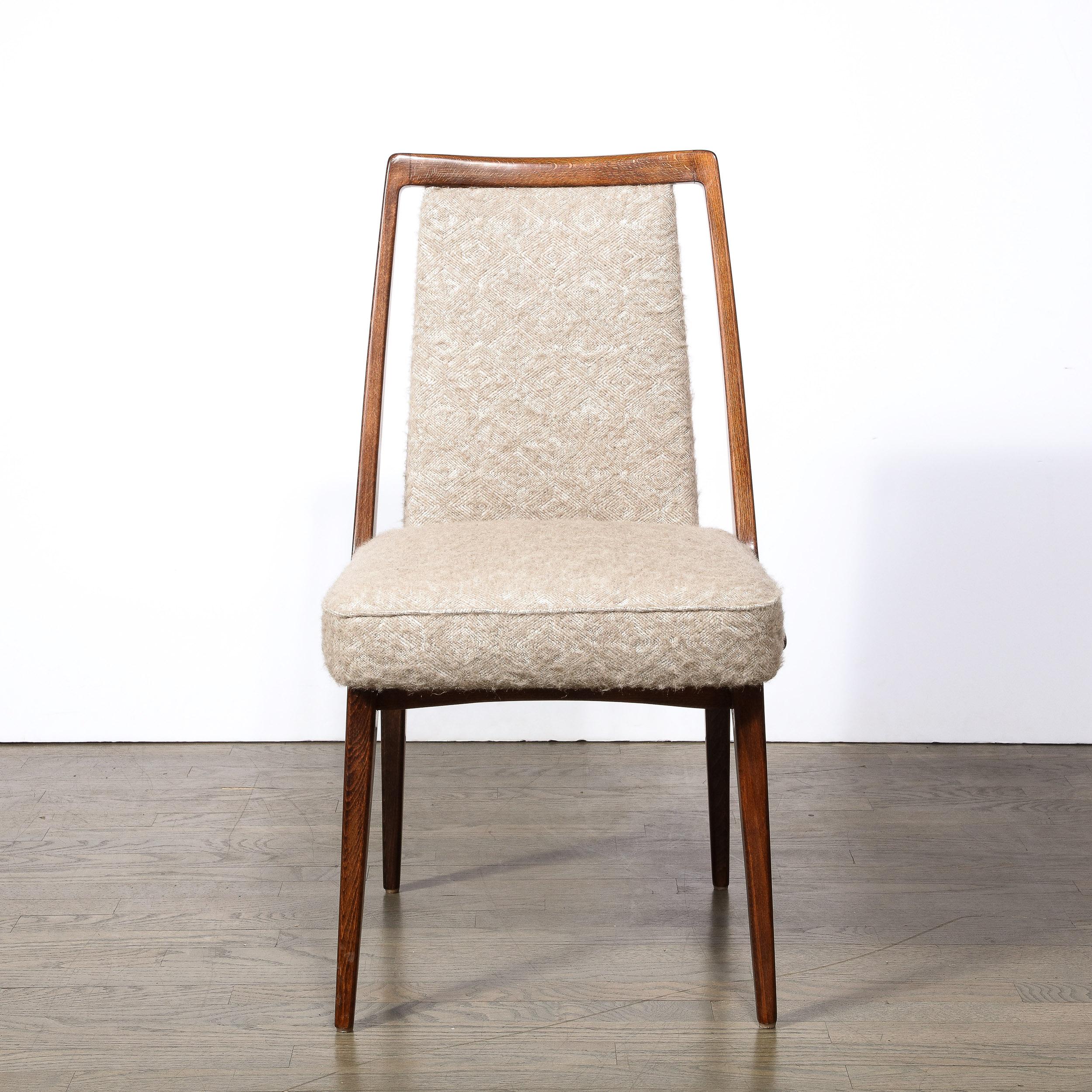 This beautiful Mid-Century Modern chair was realized in the United States circa 1960. It features an open floating rectangular walnut frame that elegantly sits around the rectangular back of the chair, and elegantly wraps around the seat. The legs