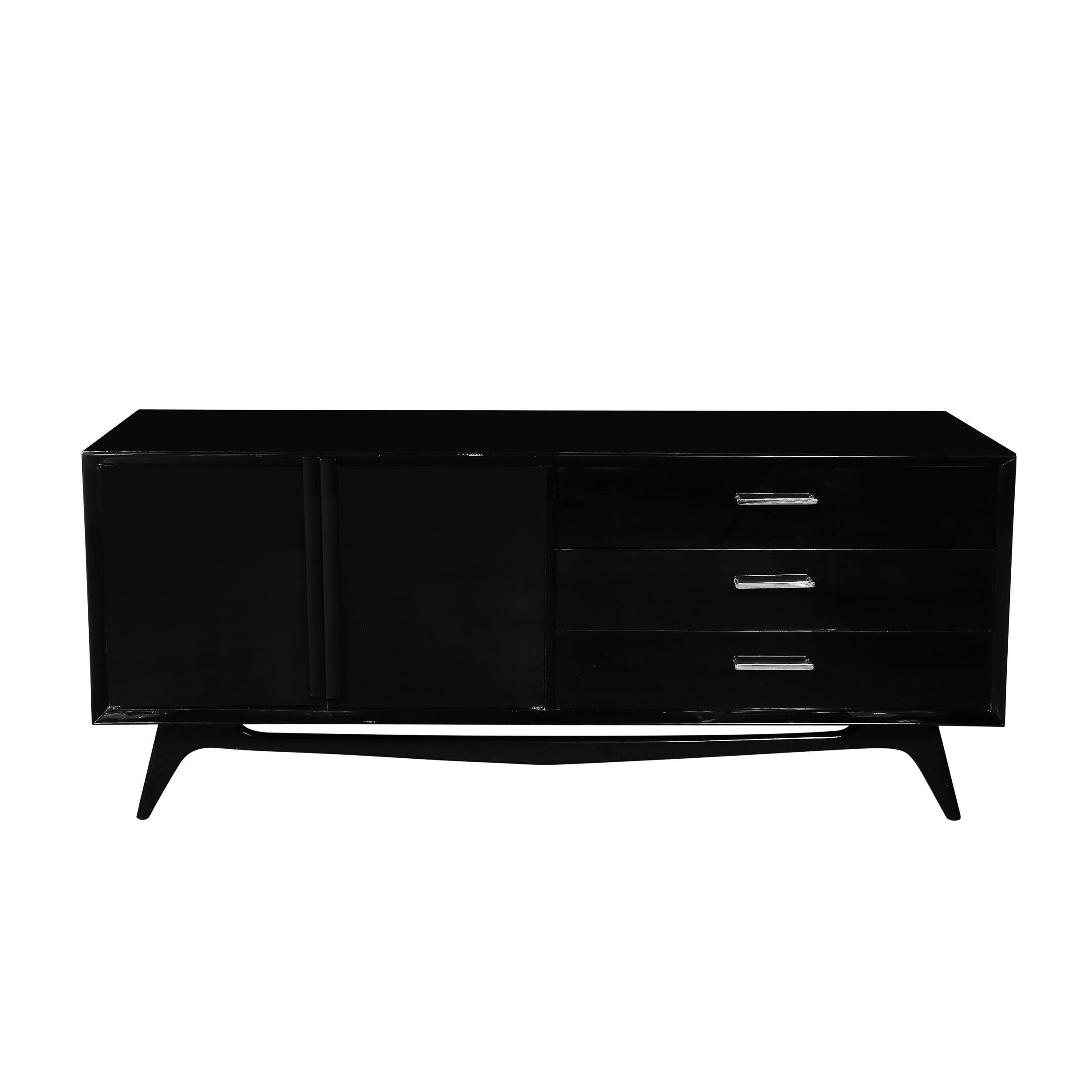 This striking mid-century modernist sideboard, dating to circa 1950, is a quintessential example of American design from the era. The sideboard features a sleek, sculptural form, finished in a sophisticated ebonized walnut that exudes timeless