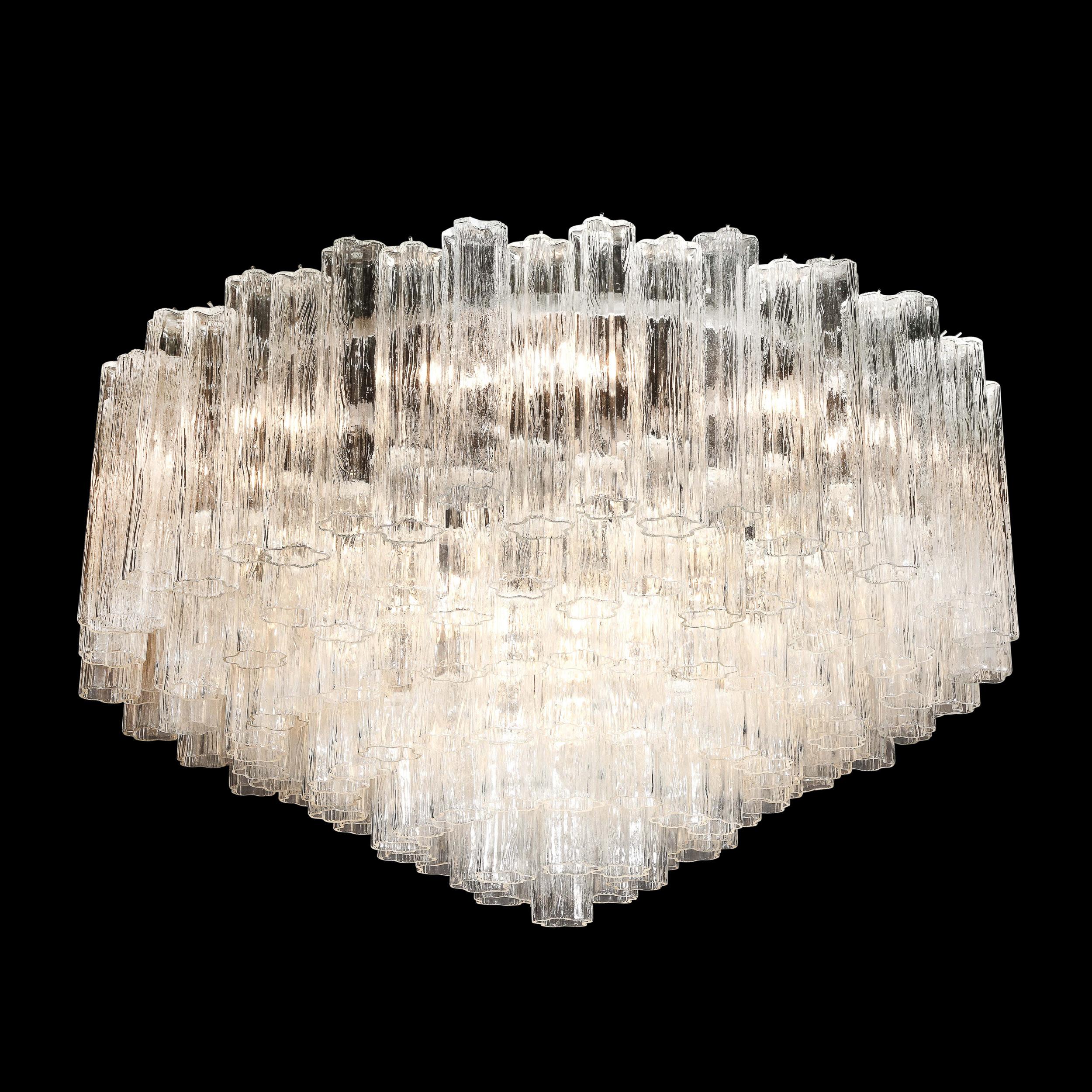 This refined and large scale modernist tronchi chandelier was realized in Murano, Italy- the island off the coast of Venice renowned for centuries for its superlative glass production. It features seven tiers of Murano tronchi crystals- one of the