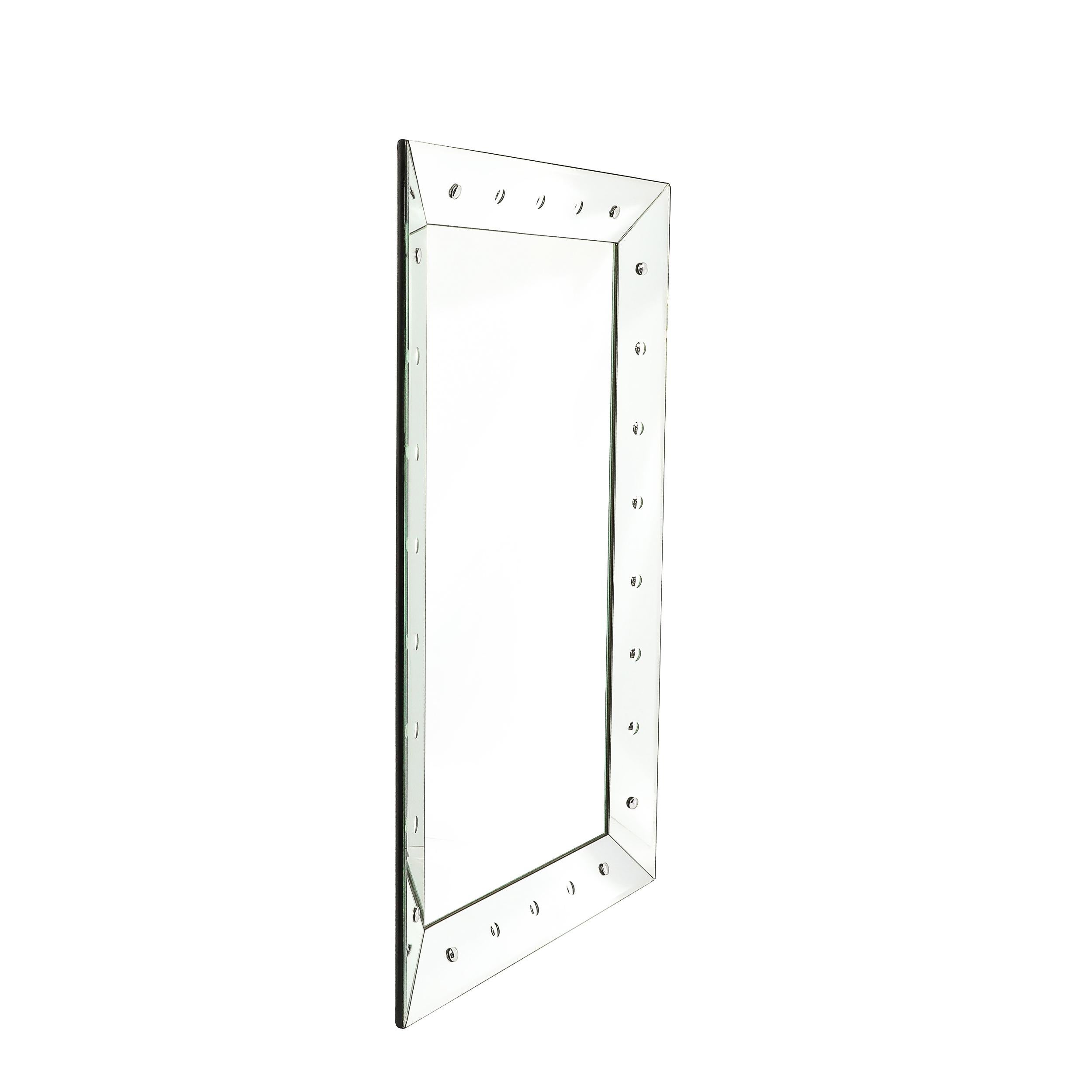 This elegantly bold Mid-Century Modernist Shadowbox Mirror W/ Reverse Beveled Detailing originates from the United States, Circa 1970. Features a shadowbox design with reversed beveled detailing, a wide border and a stunning presence. Large in scale