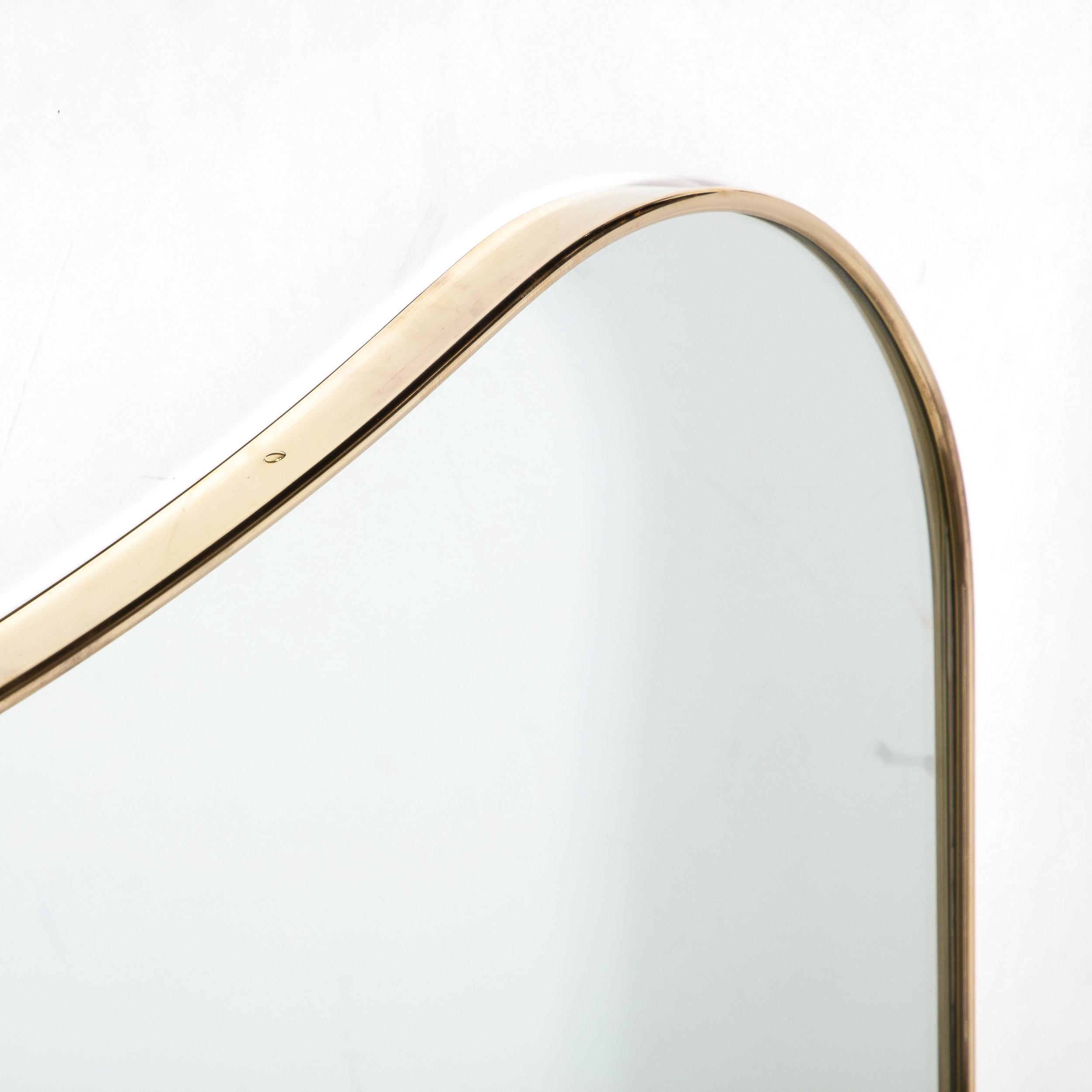 Mid-20th Century Mid-Century Modernist Shield Form Polished Brass Wrapped Mirror For Sale