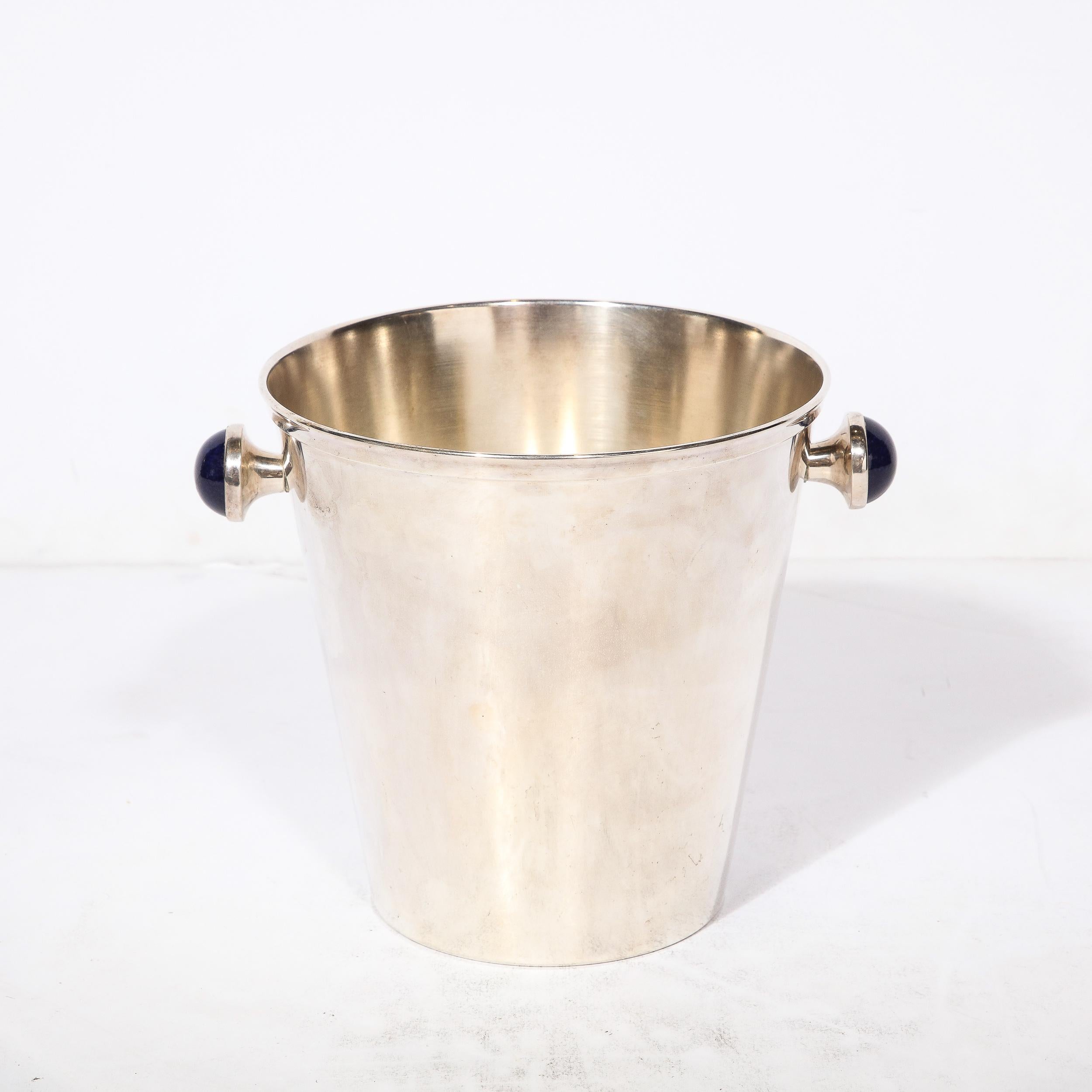 This stunning and rare Mid-Century Modernist  Silver Plate Ice Bucket originates from France, Circa 1950. A true gem brimming with elegance, the rounded handles are inlaid with genuine Lapiz Laulie, a highly rare and sought after mineral originating