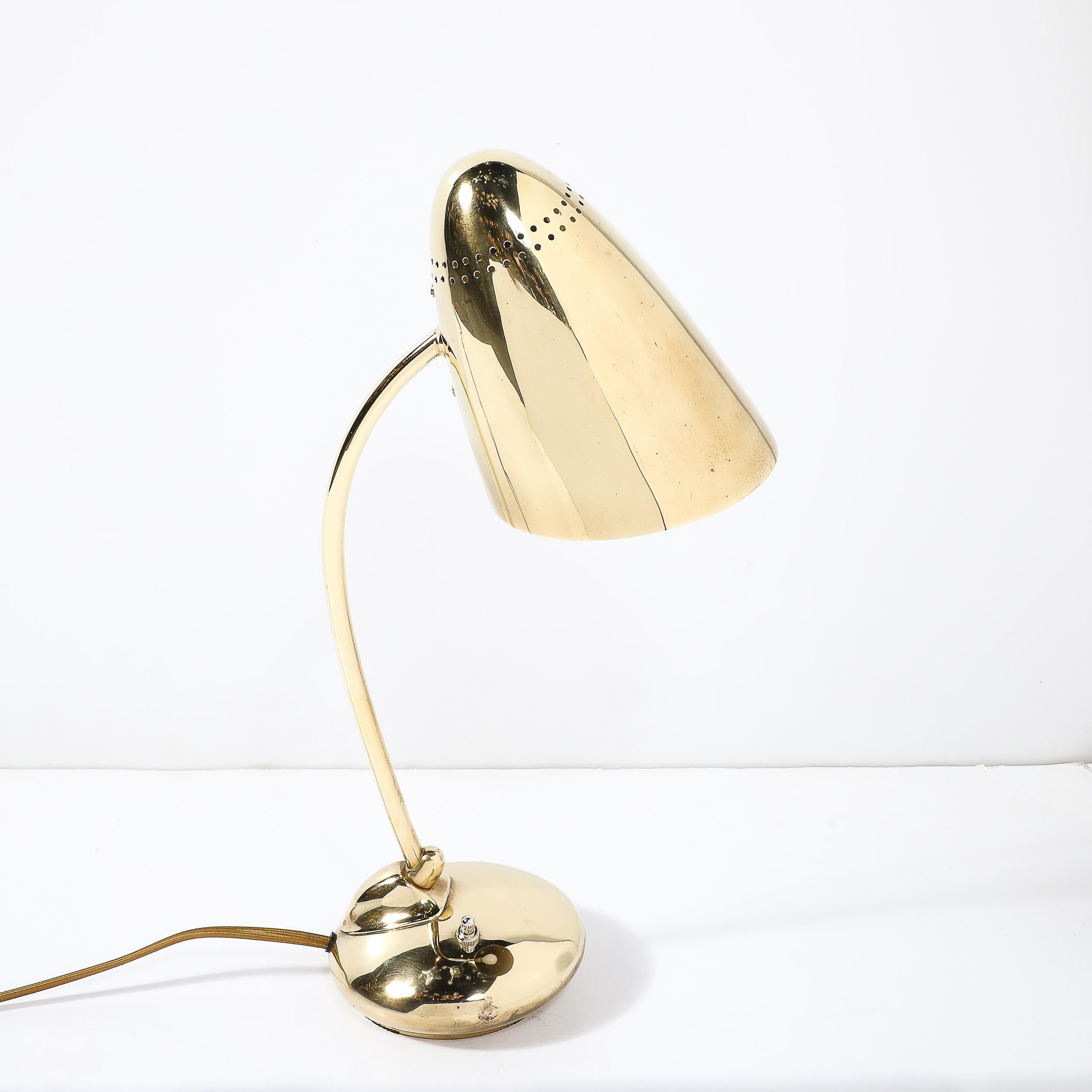 This Mid-Century Modernist Space Age Polished Brass Table Lamp originates from the United States, Circa 1960. This piece is a remarkable fusion of innovation and style emblematic of the era. Its sleek design captures the futuristic aesthetic that