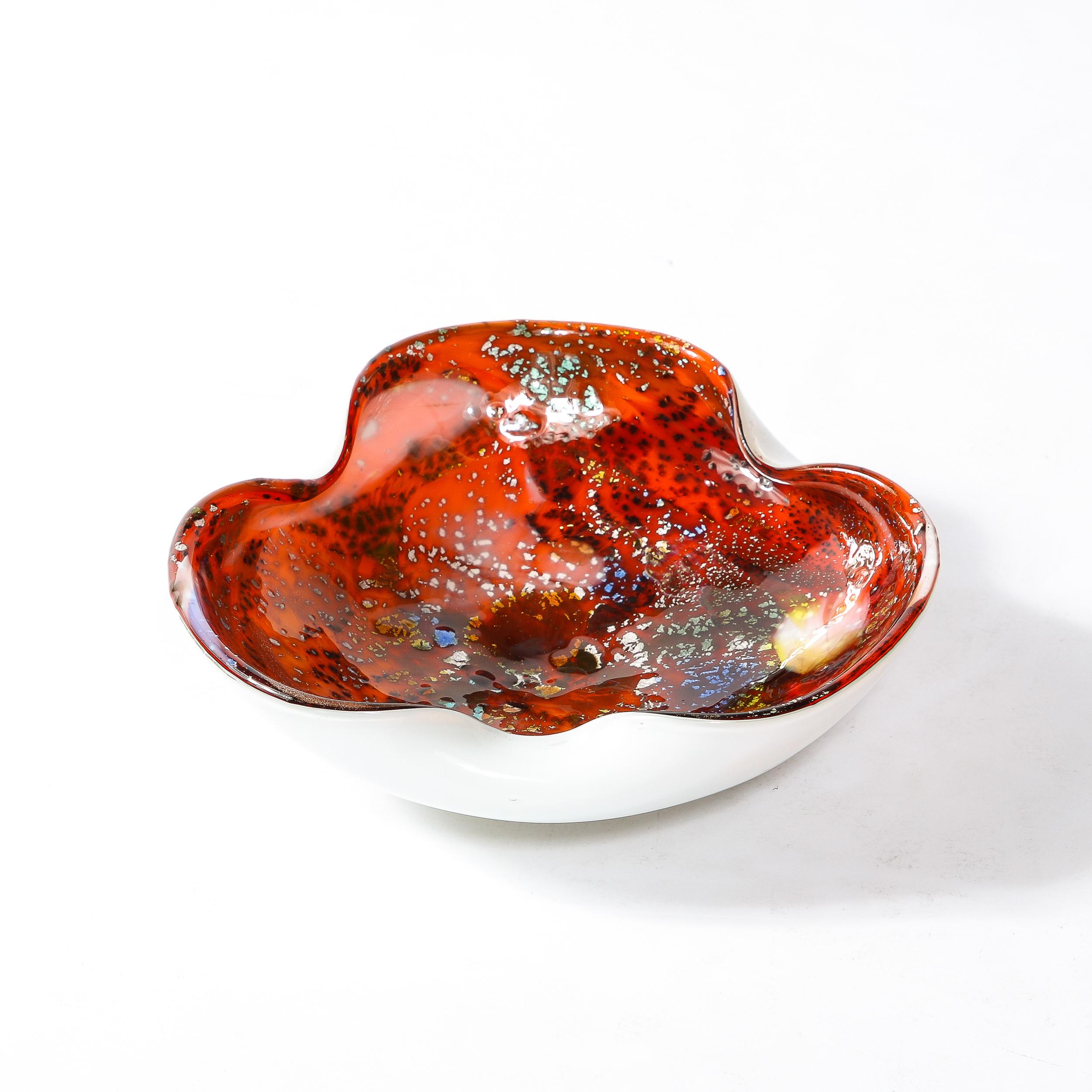 -This eye catching Mid-Century Modernist Dish originates from Italy, Circa 1960. Featuring a circular form with three indentations revealing the undersurface in a lovely cool white, the interior contrasts starkly in a bright red with speckled glass