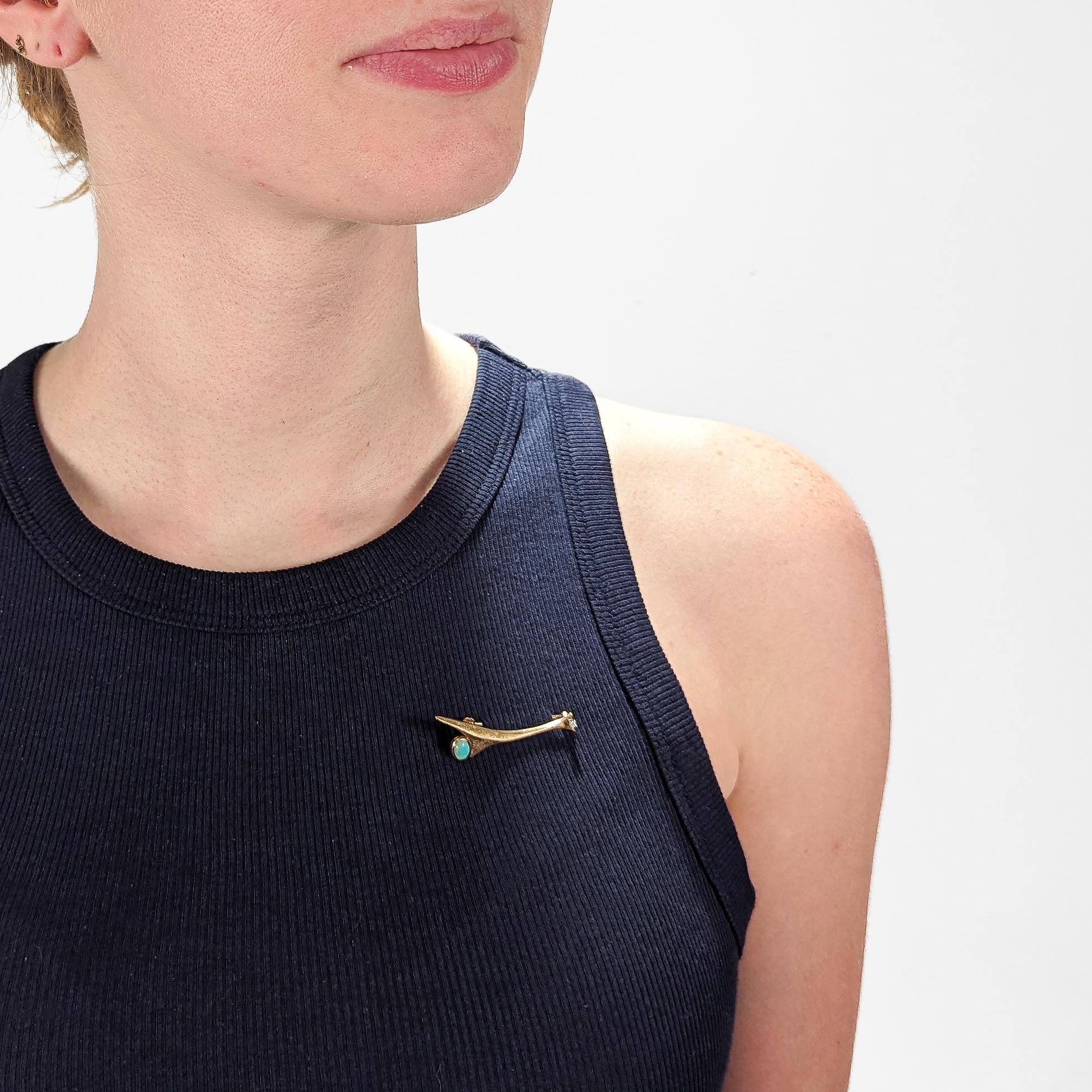 A fine Mid-century brooch or pin.

In 10k gold with a textured finish. 

Bezel set with an opal doublet cabochon and a small round cut white diamond.

Set with a hinged pin and catch to the reverse.

Simply a wonderful Modernist