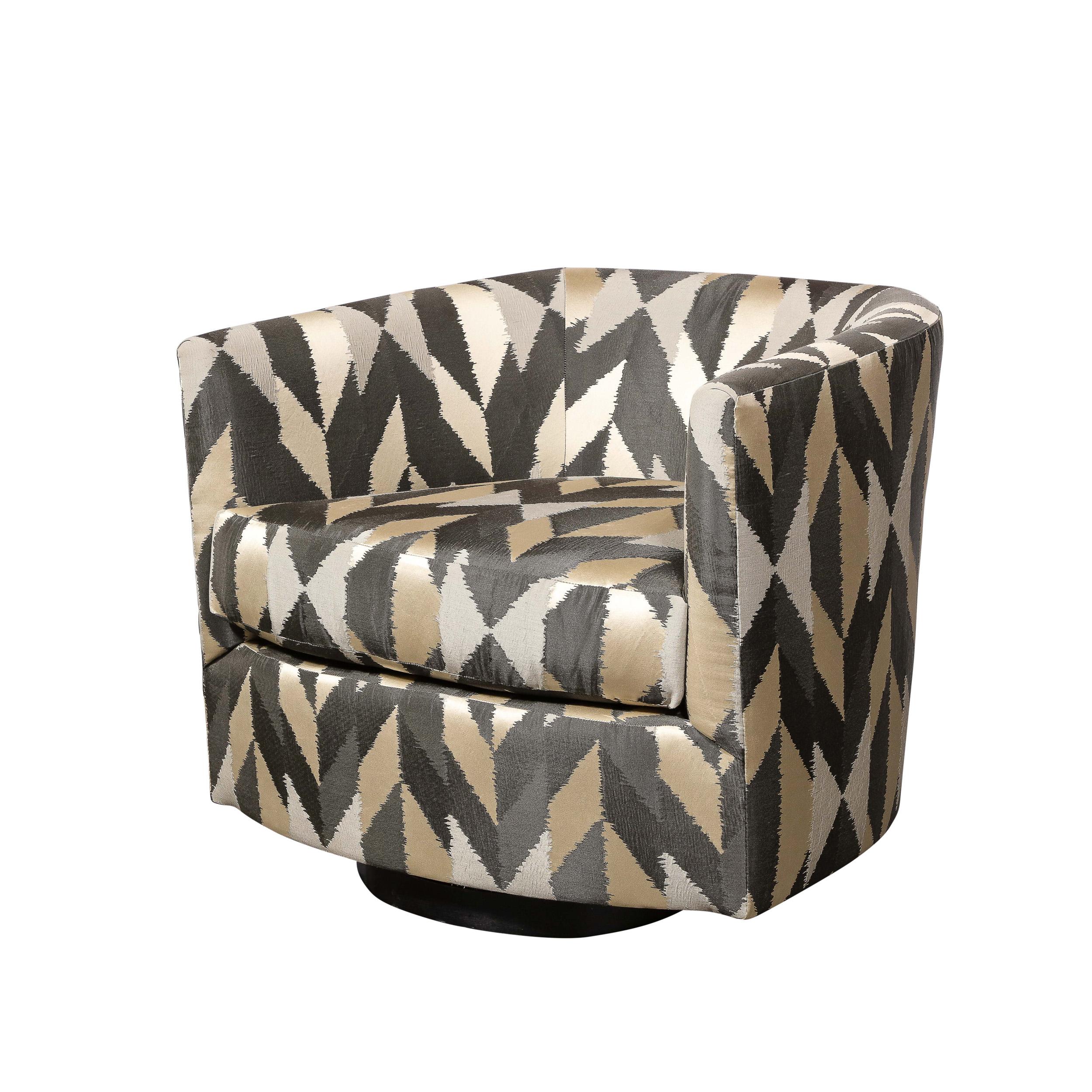 An excellent example of mid-century modern design and craftsmanship, this pair of swivel chairs features a beautifully coordinated fabric with staggered geometric pattern and silver, pewter, and pale gold tones. These chairs are characteristic of