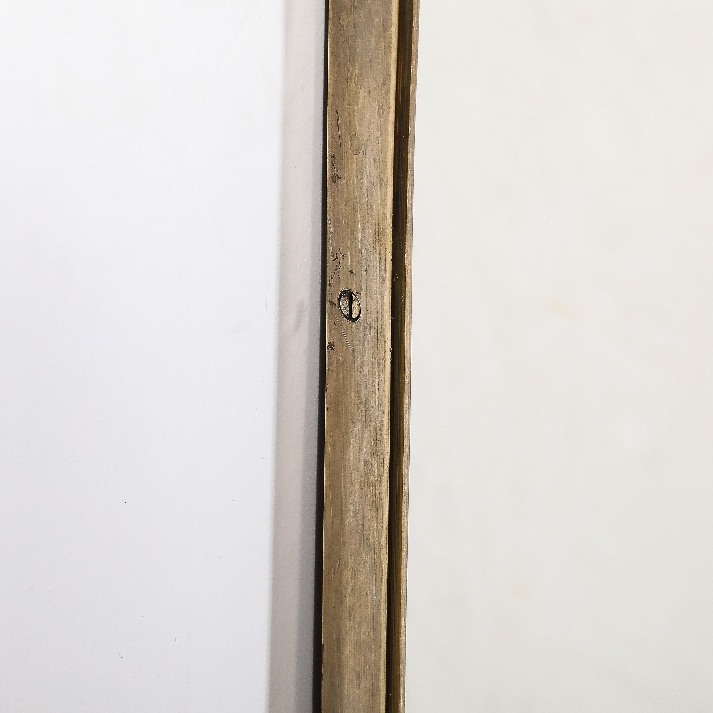 Mid-Century Modernist Tapered Brass Wrapped Mirror with Concave Top Detailing In Excellent Condition For Sale In New York, NY