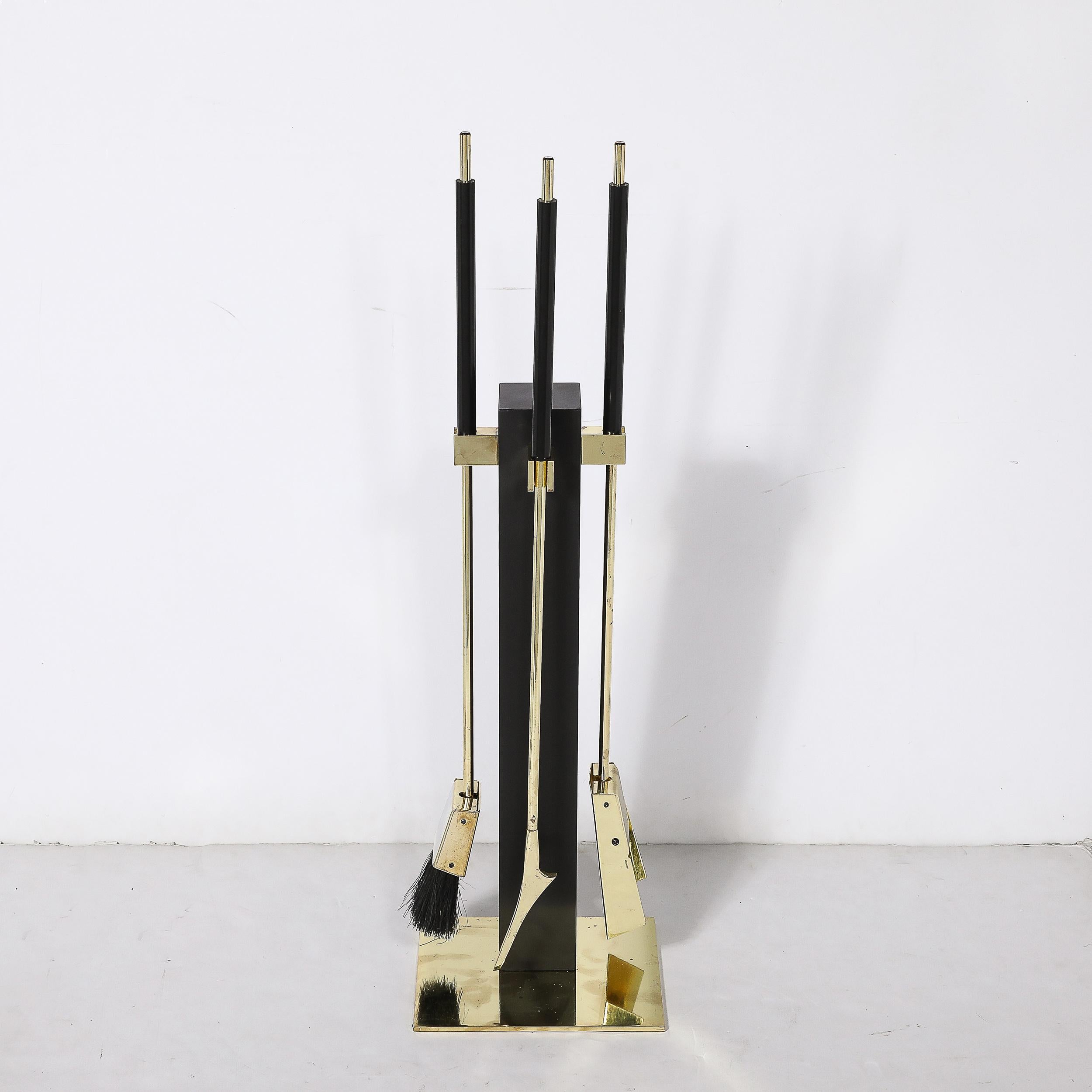 This sleek and sophisticated Mid-Century Modernist Three Piece Fire Tool Set in Polished Brass and Black Enamel by Alessandro Albrizzi originates from the Italy, Circa 1970. Features an excellent balance of slender rounded and rectilinear forms,