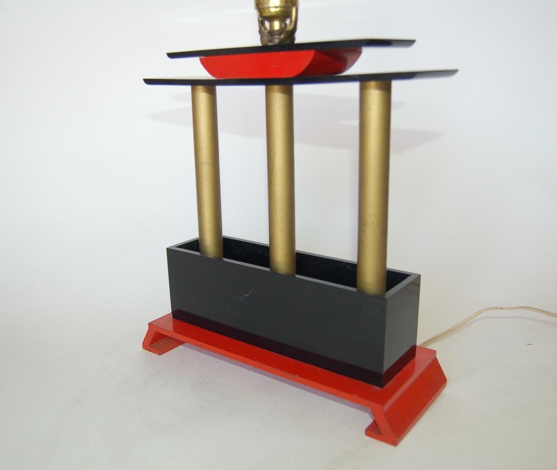 Mid-Century Modernist arch mixed-media table lamp modeled after a Japanese Torii. The lamp is constructed of metal poles, wood, and sheets of Lucite. Measures 12