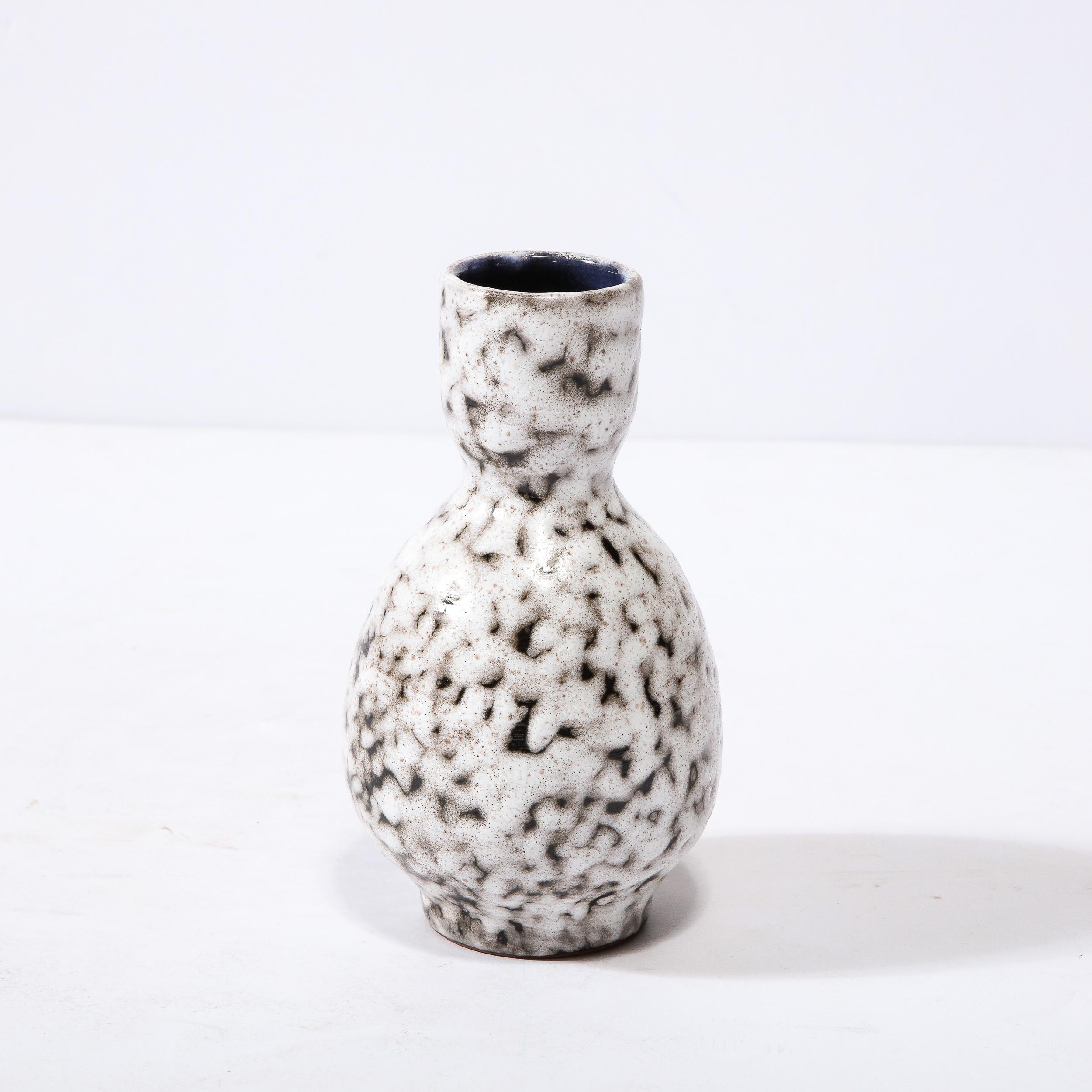 This Mid-Century Modernist Ceramic Vase is a beautiful example of Post War European Ceramics, realized in Hódmezovasarhely Majolikagyár, Hungary Circa 1960. With a Stunning textural finish composed in Cream White and Blackened Umber, the surface of