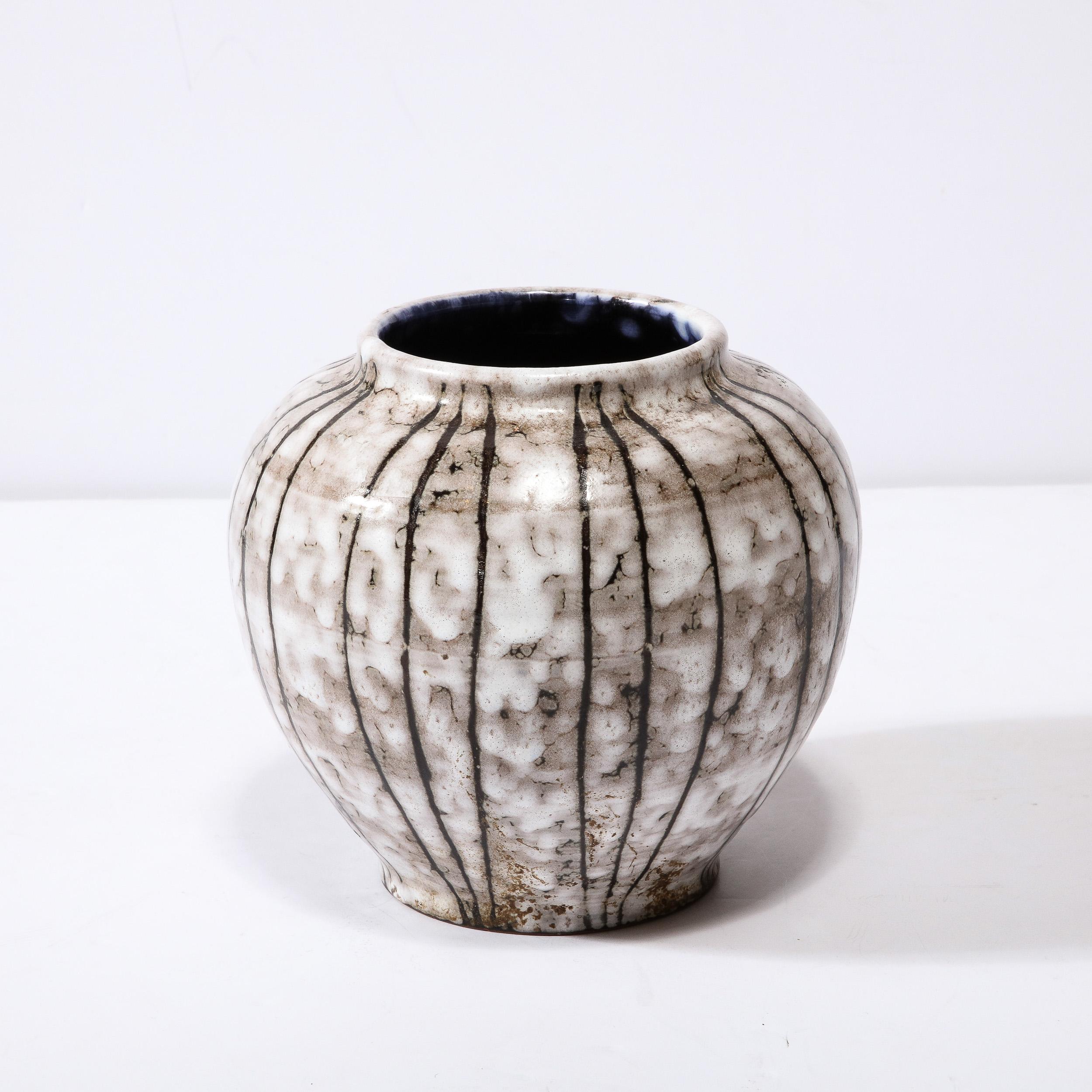 This Mid-Century Modernist Ceramic vase W/ Bowed Line Work is a beautiful example of Post War European Ceramics, realized in Hódmezovasarhely Majolikagyár, Hungary Circa 1960. With a Stunning textural finish composed in Cream White and Blackened