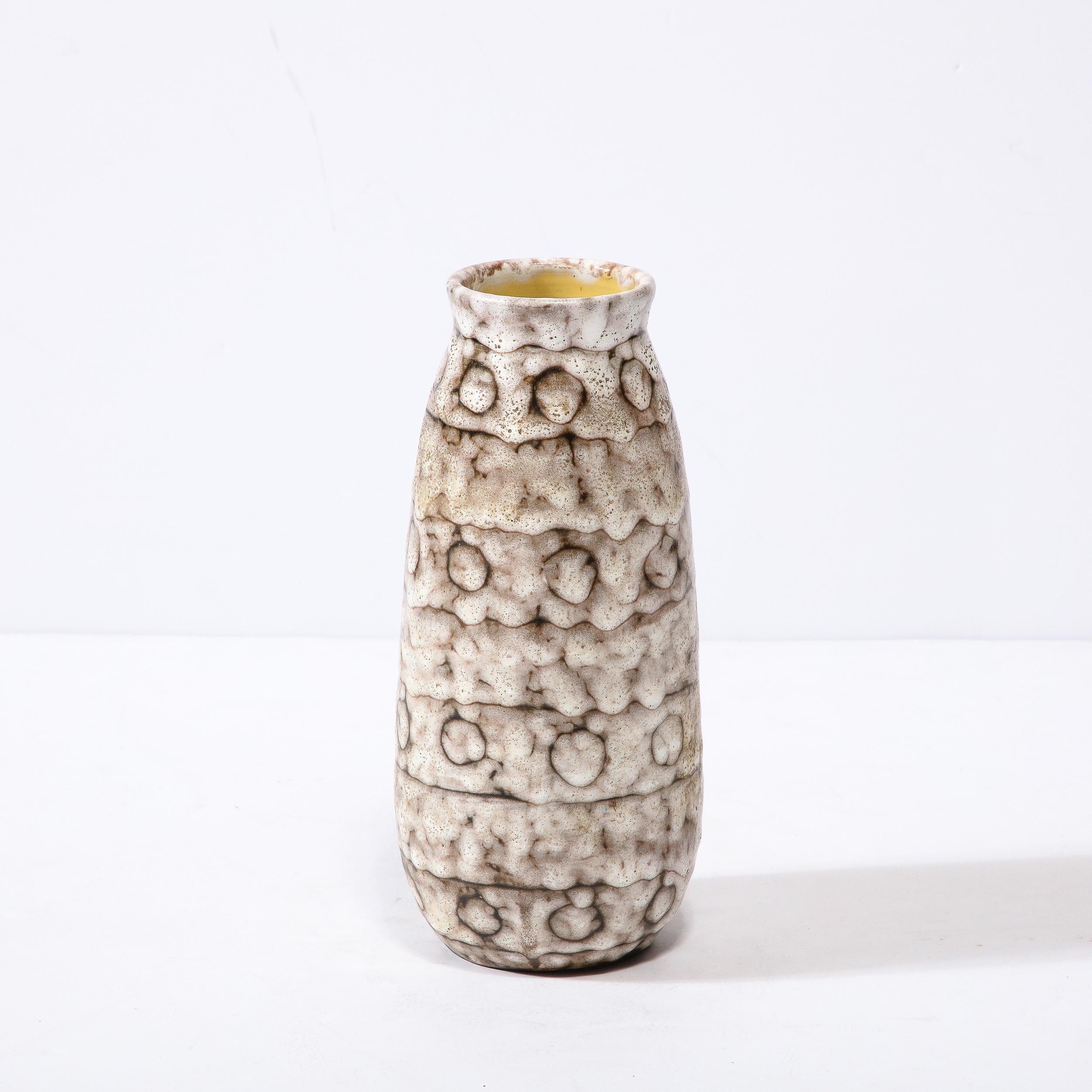 This Mid-Century Modernist Ceramic Vase with Spotted Banding is a beautiful example of Post War European Ceramics, realized in Hódmezovasarhely Majolikagyár, Hungary circa 1960. With a Stunning textural finish composed in Cream White and Blackened