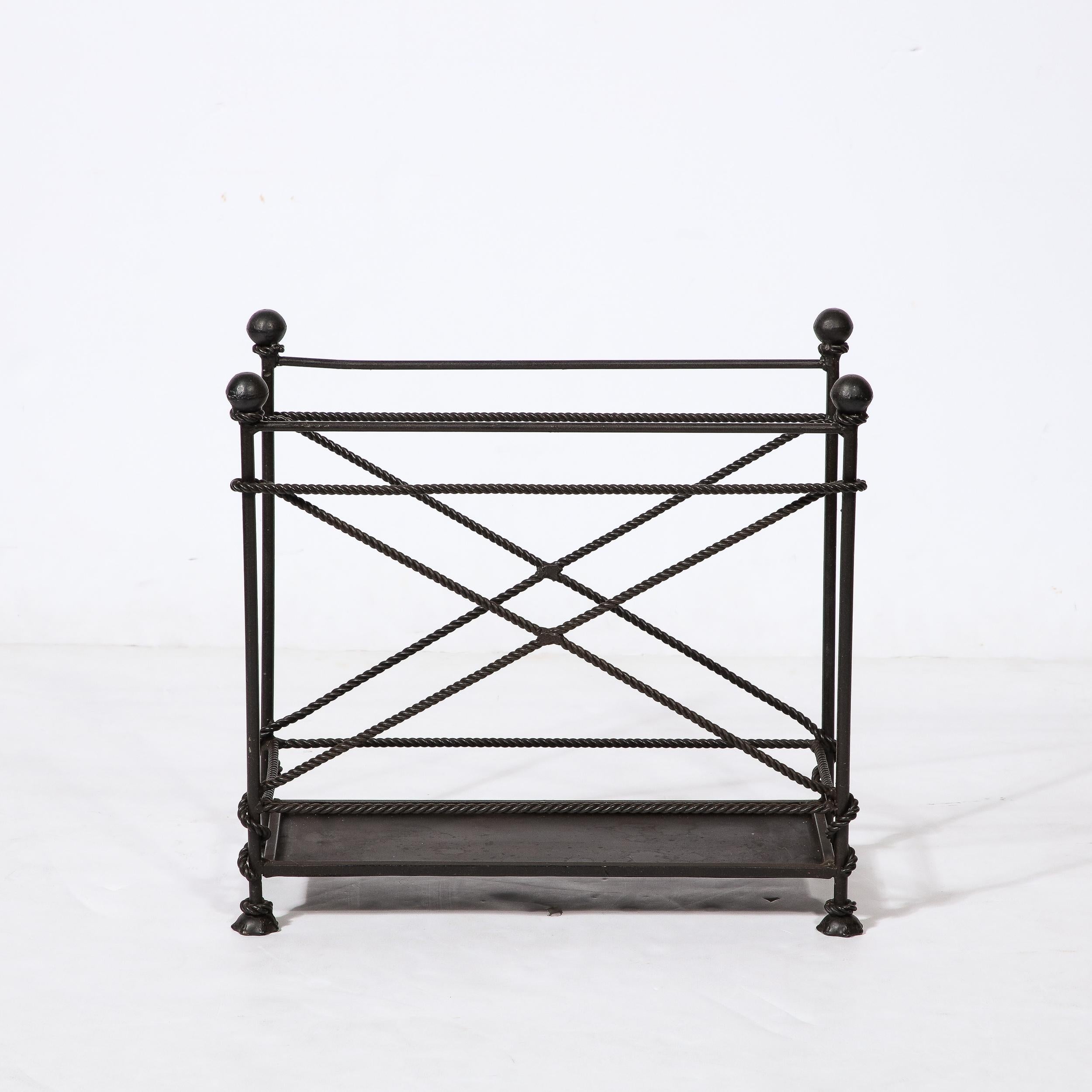 This cleverly designed Mid-Century Modernist Wrought Iron Rope Motif Magazine Stand originates from the United States, Circa 1950. Features a minimal construction in wrought iron, with a raised lip panel elevated with lovely sculptural feet. From