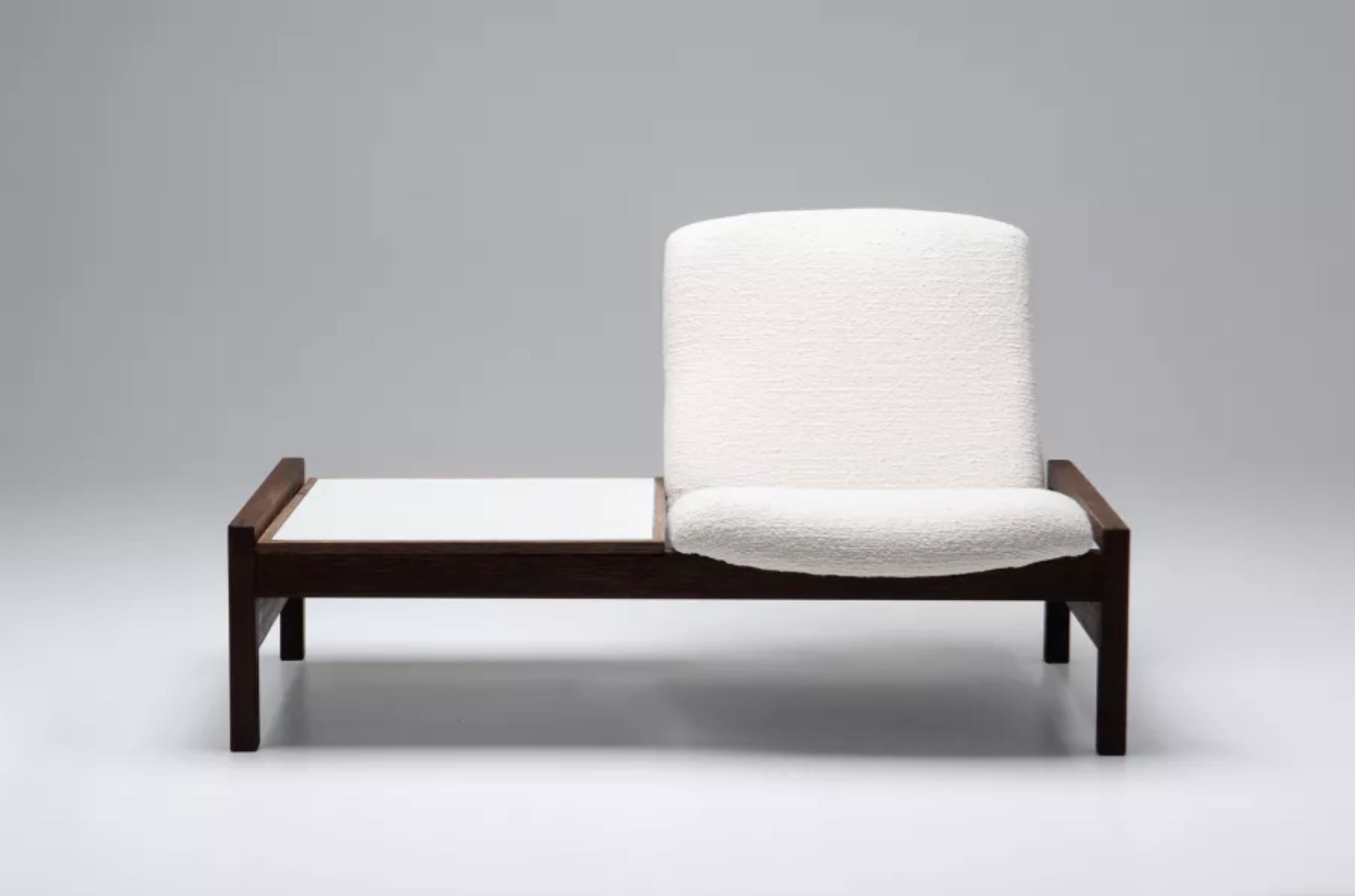 Minimalist modular sofa with integrated coffee table with a white laminated table top. Designed by Belgian designer Georges van Rijck for Beaufort in the 1960s.  These parts are interchangeable, allowing the sofa to be transformed. 
We also have an