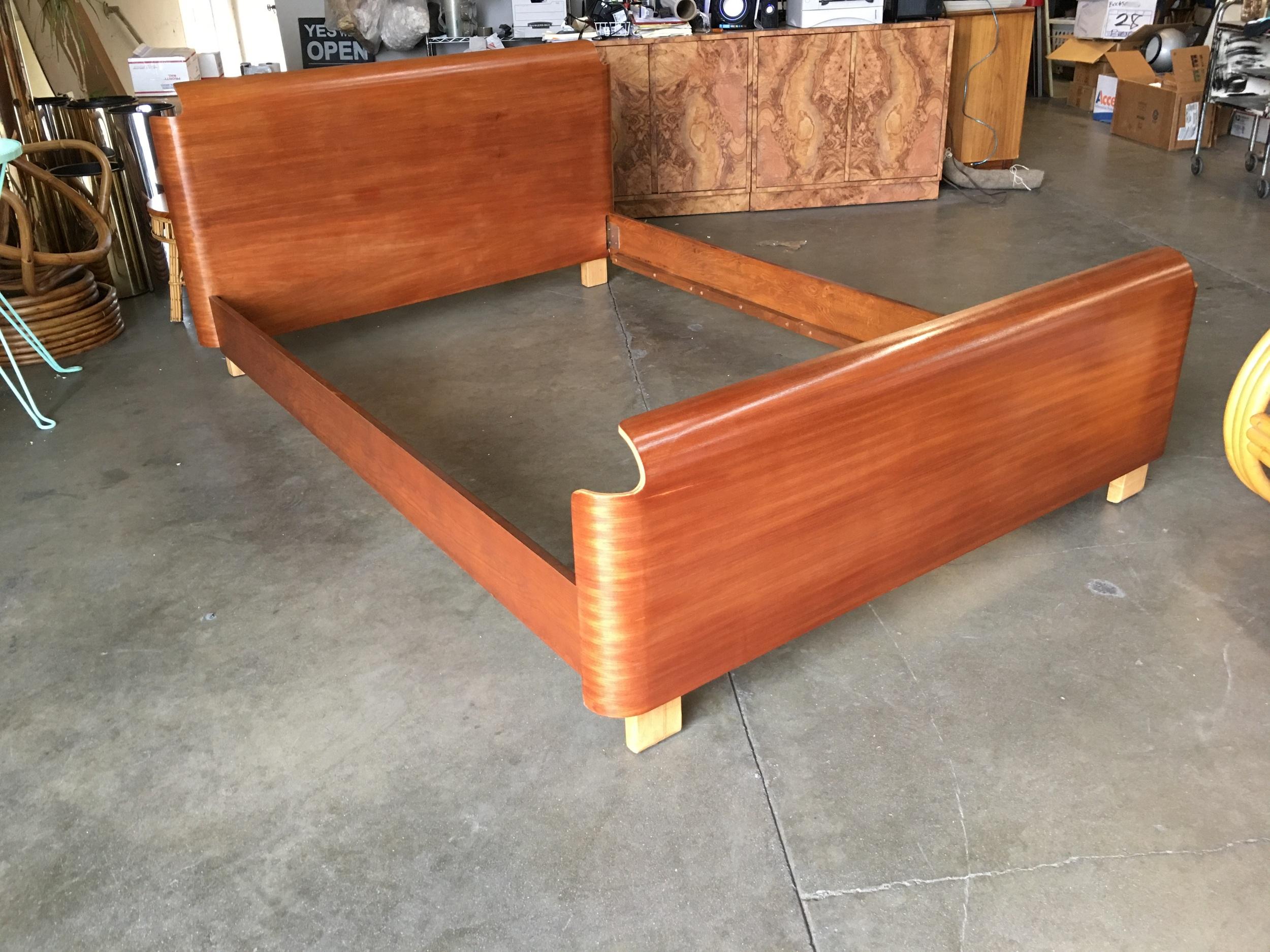 This Mid-Century Modern full-sized bed frame with a dark stained bent plywood head and footboard.

Headboard: 33