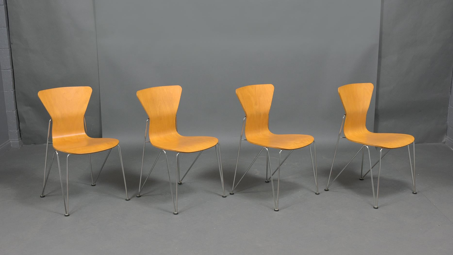 An extraordinary set of four mid-century molded plywood chairs beautifully crafted and newly professionally restored by our craftsmen. This fabulous set is in great condition has been newly stained in a maple color with a lacquered finish. This