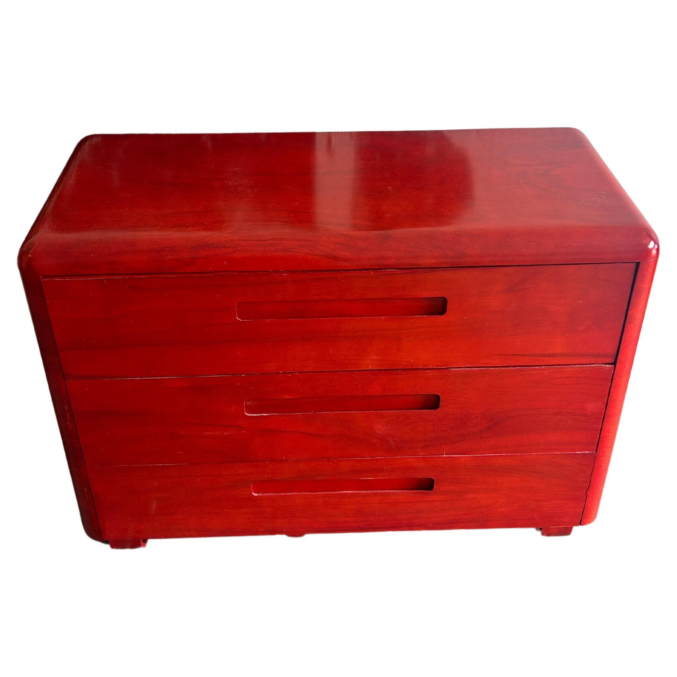 Mid century molded plywood low 3 drawer dresser by Paul Goodman for plymold In red Lacquer. Has rounded design with inset handles with bentwood curved drawers and legs. Good vintage condition. Located in Brooklyn NYC.

Measures 46” x 19” x 33”