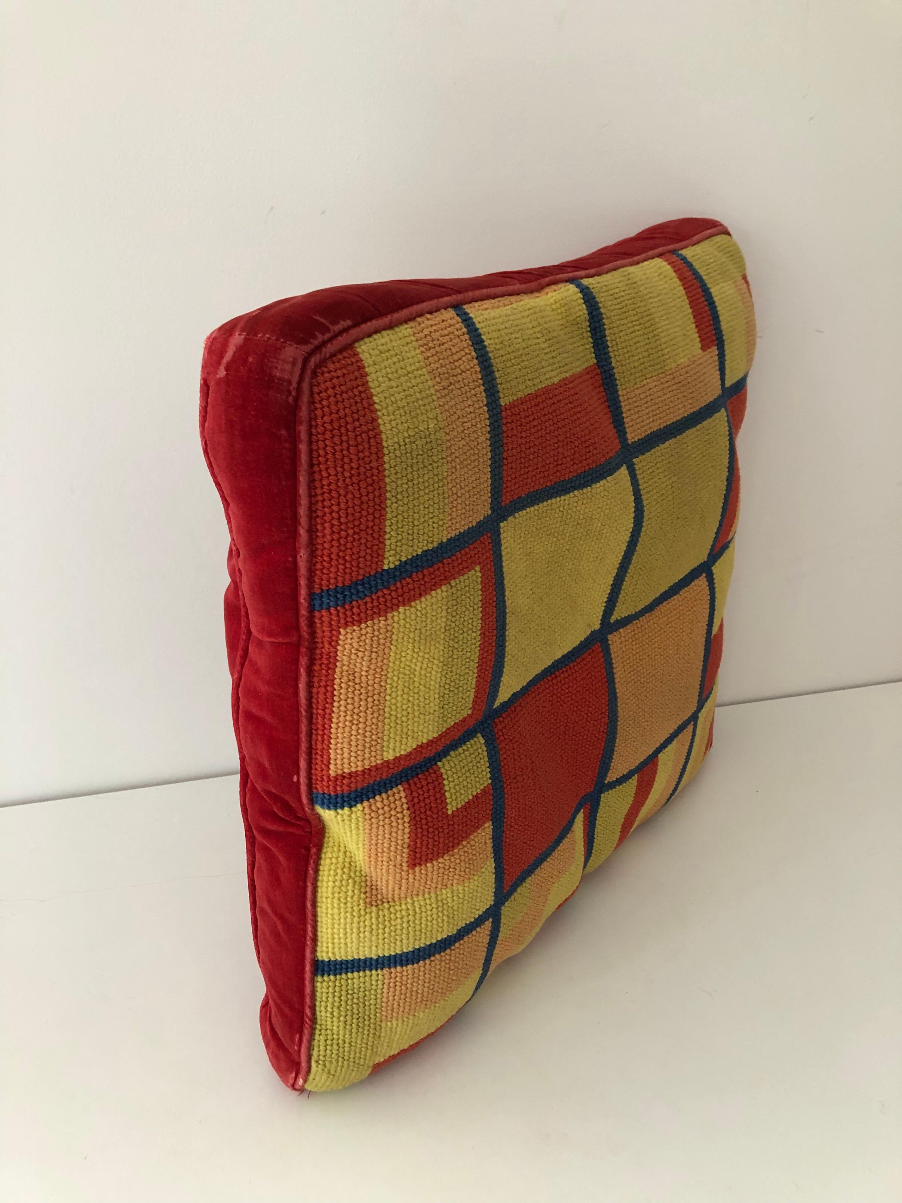 A handmade midcentury Mondrian inspired needlepoint pillow with red velvet back. Tones of red, cyon, mustard, and yellow. Two associated pillows also available.