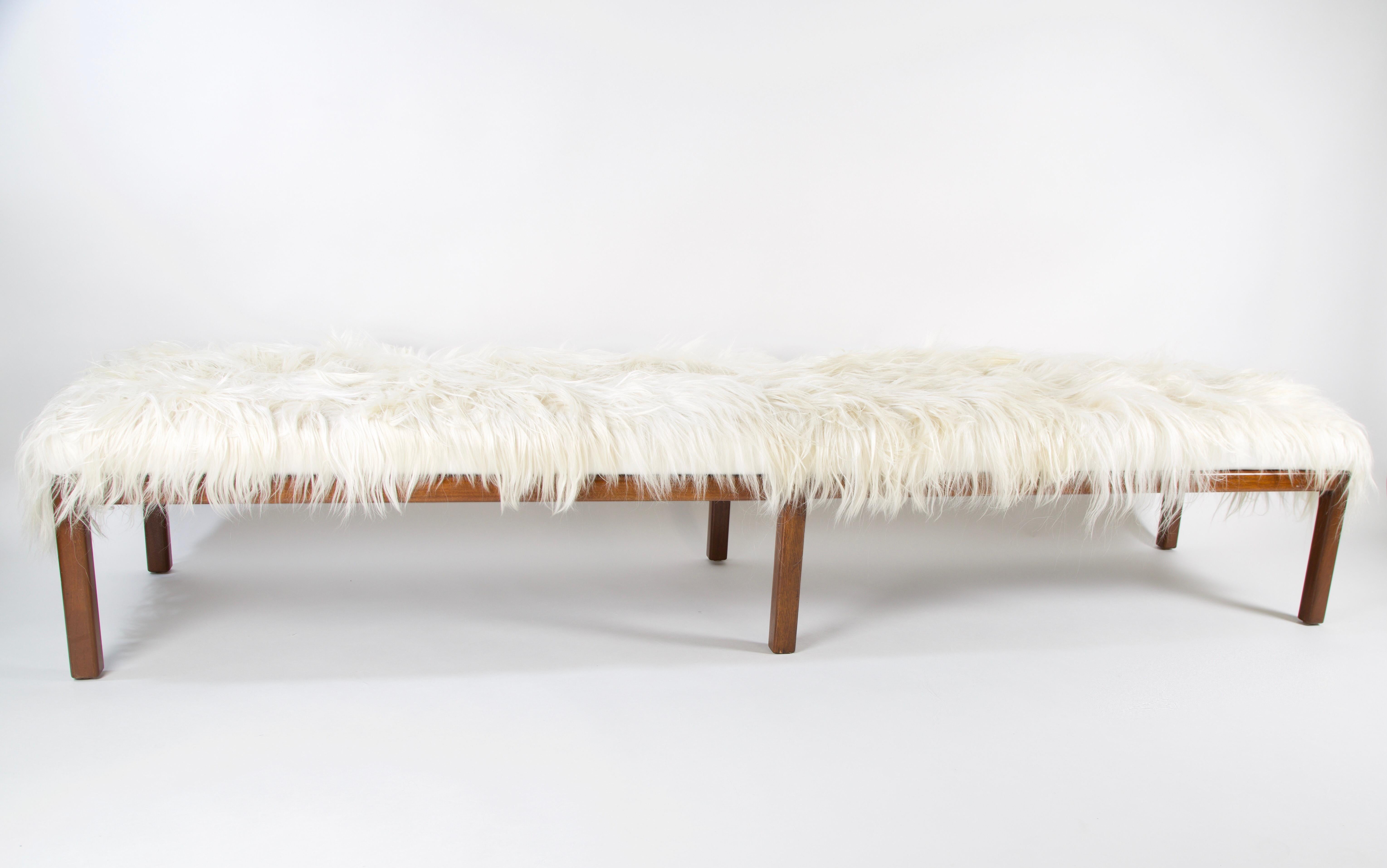 Midcentury Mongolian fur bench was originally used in the LACMA, Los Angles County Museum of Art. This piece is very sleek with clean lines and rest on 6 straight hardwood legs. It was refinished and reupholstered in white Mongolian hide and white