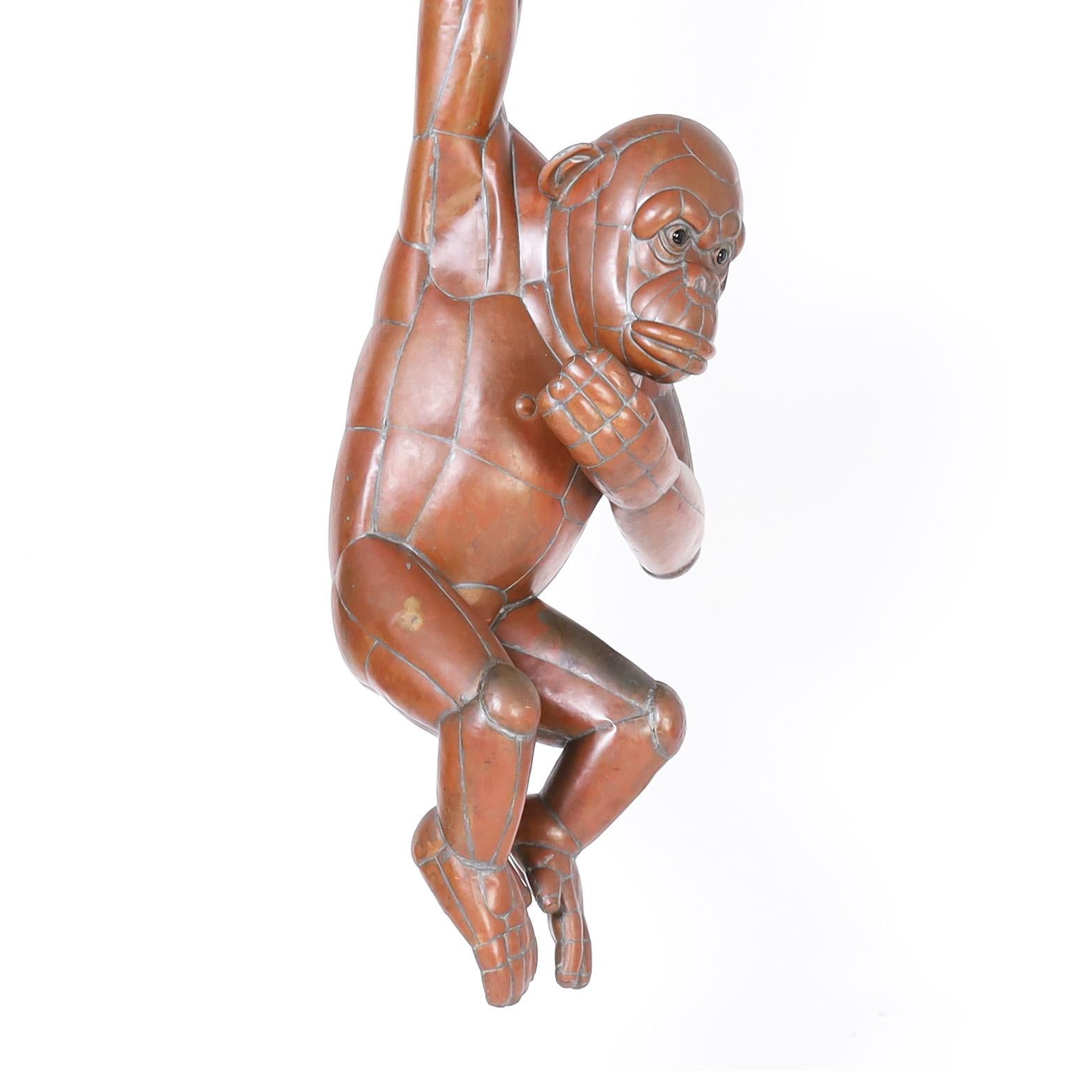 Striking mid century sculpture of a chimpanzee hanging from a trapeze, crafted in copper by Sergio Bustamante with both whimsy and stylized accuracy and having an acquired bronze like sculptural patina. Signed Sergio Bustamante 47/100.