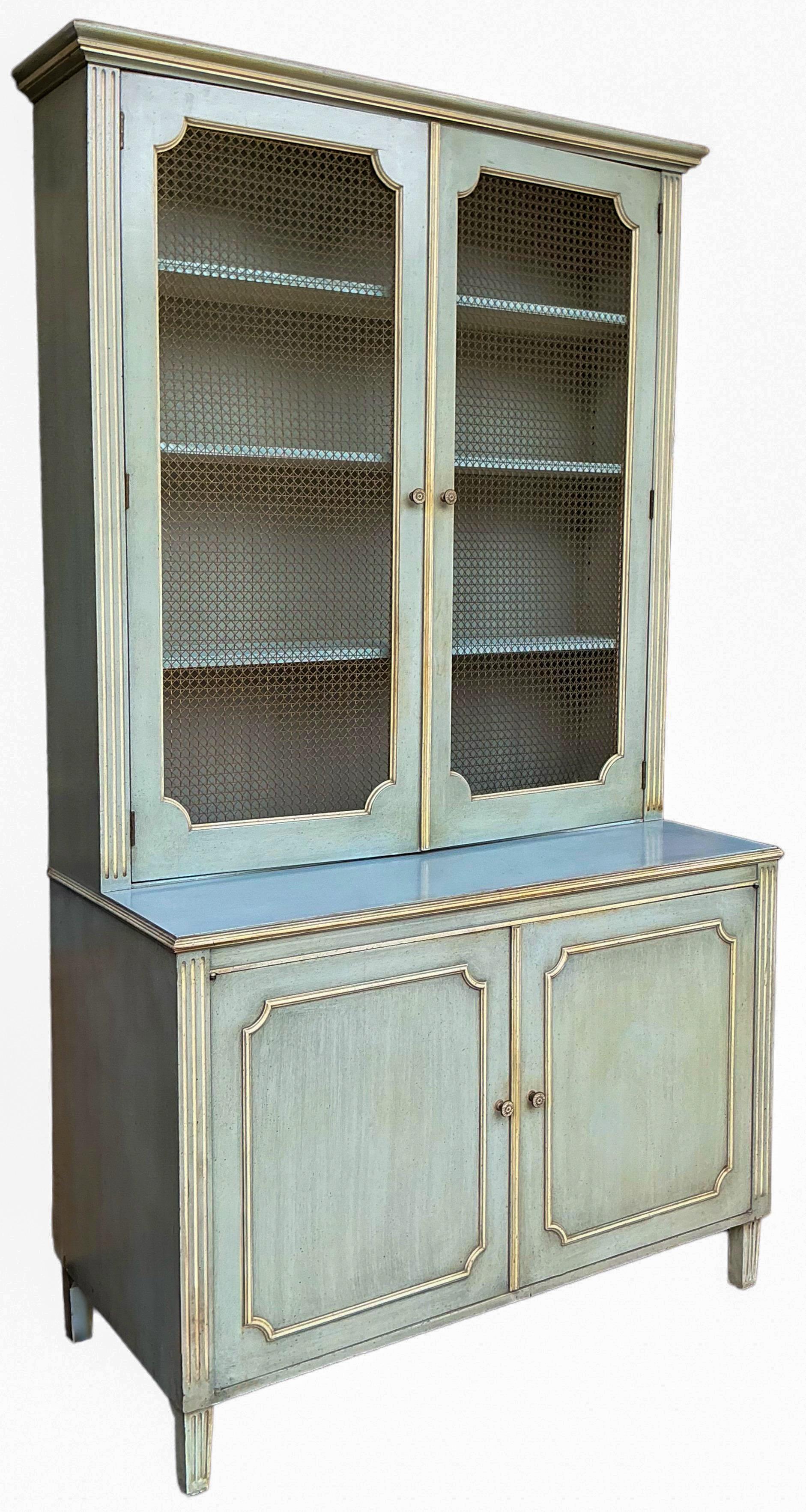 This is a pair of monumental mid-century French Blue and cream painted cabinets. They are custom pieces crafted in New York in the 1960s. The shelves are adjustable. The cabinet doors have wire fronts. The lower portion is 33.5” deep. The top