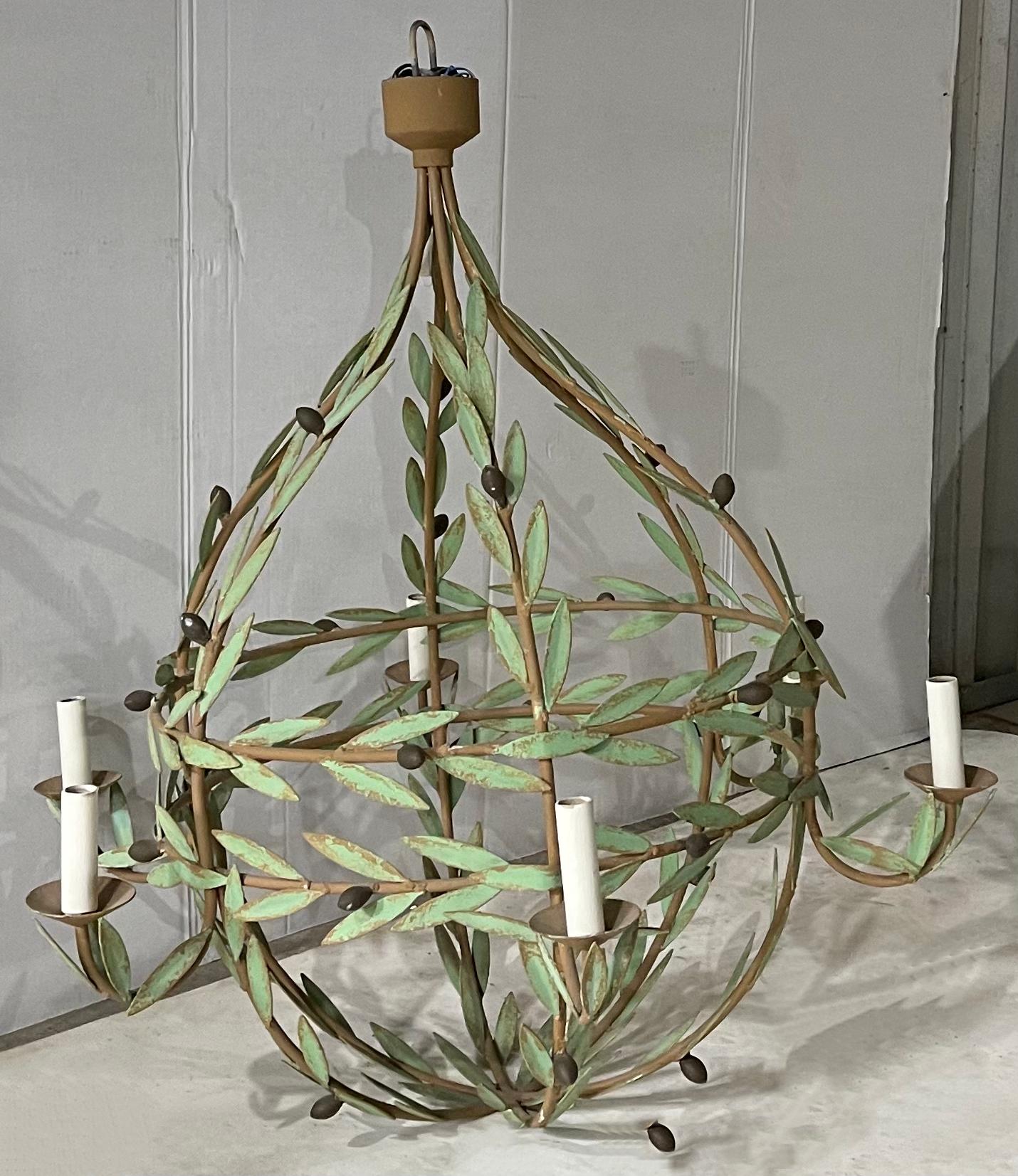 This is amazing! I have never seen this style before this one! This is a large scale tole chandelier with olive branches wrapping the frame horizontally and vertically. It is a mid-century find, and the leaves show some wear. There are six arms, and