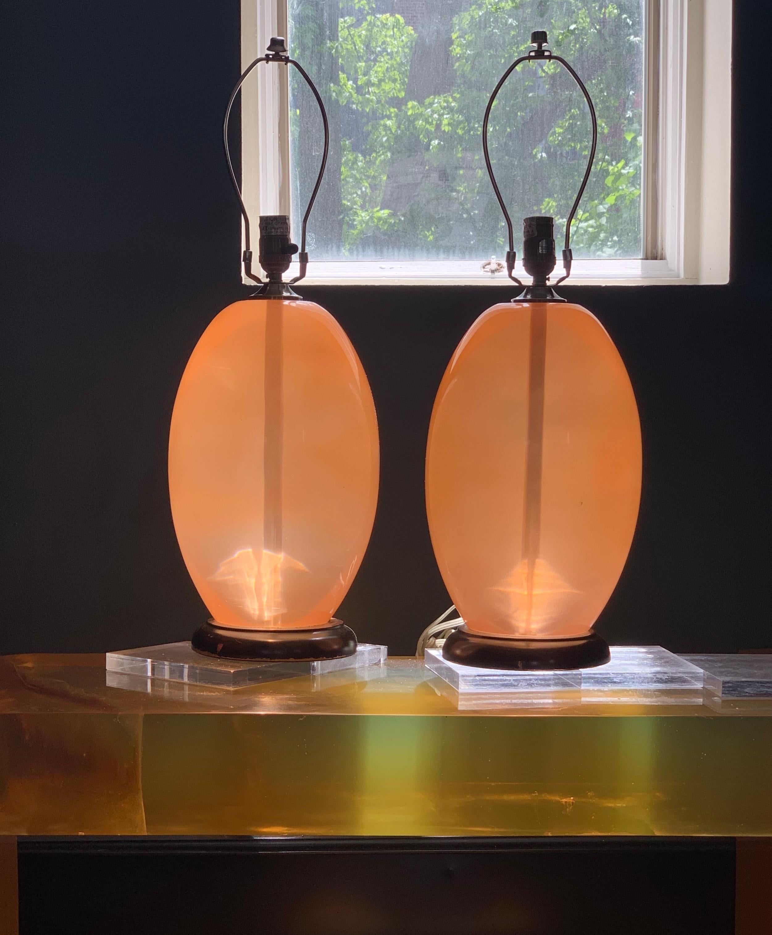 Midcentury monumental ostrich-egg pink Lucite or Resin or Acrylic modern sculptural table lamp. Wood base. Listing is for single lamp. Two available. Landshades NOT included.