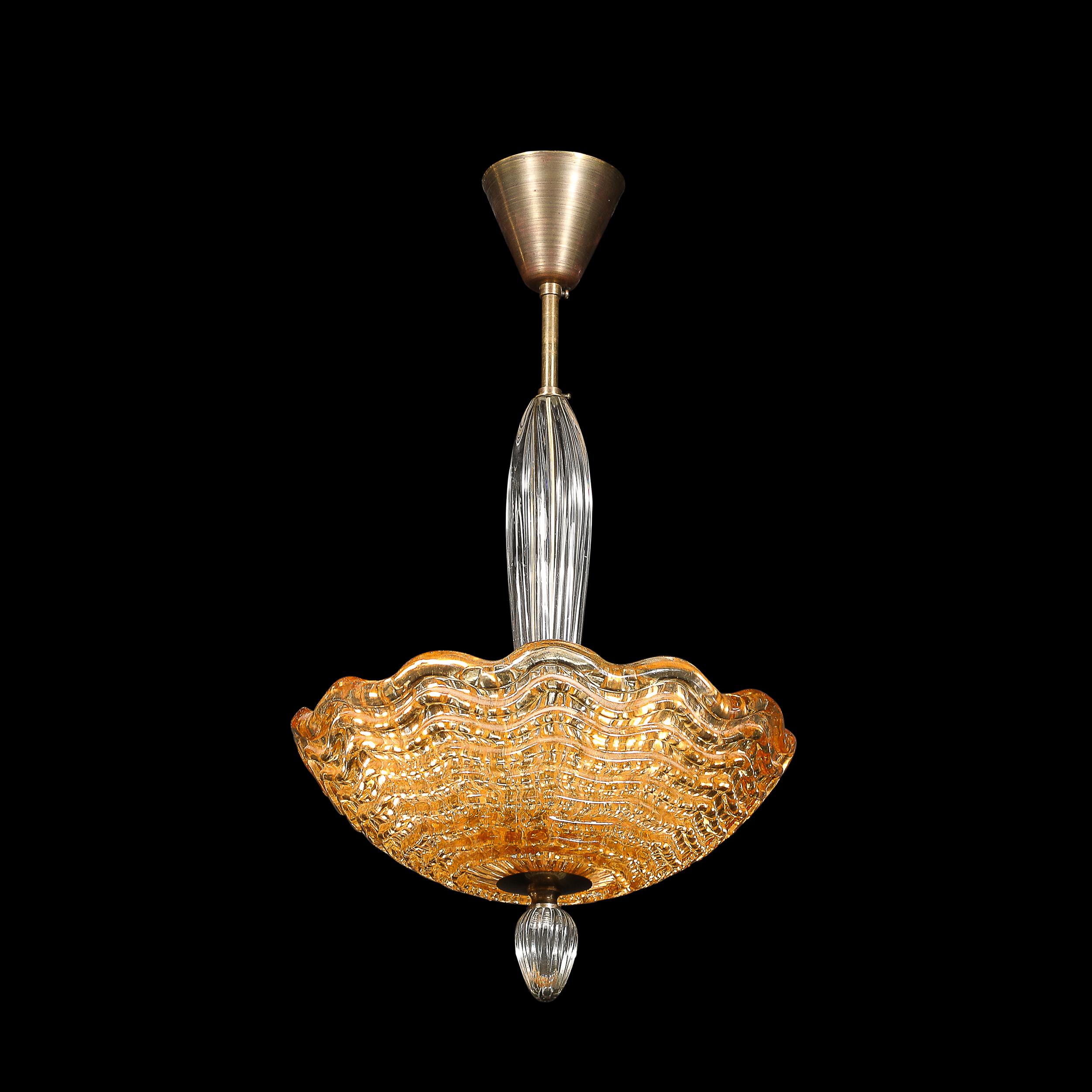 A masterwork of Scandinavian design, this mid-century pendant chandelier by Orrefors exemplifies refined craftsmanship and artistic subtlety. The shade features a stunning interplay of amber-hued glass, imparting a warm glow that evokes a sense of