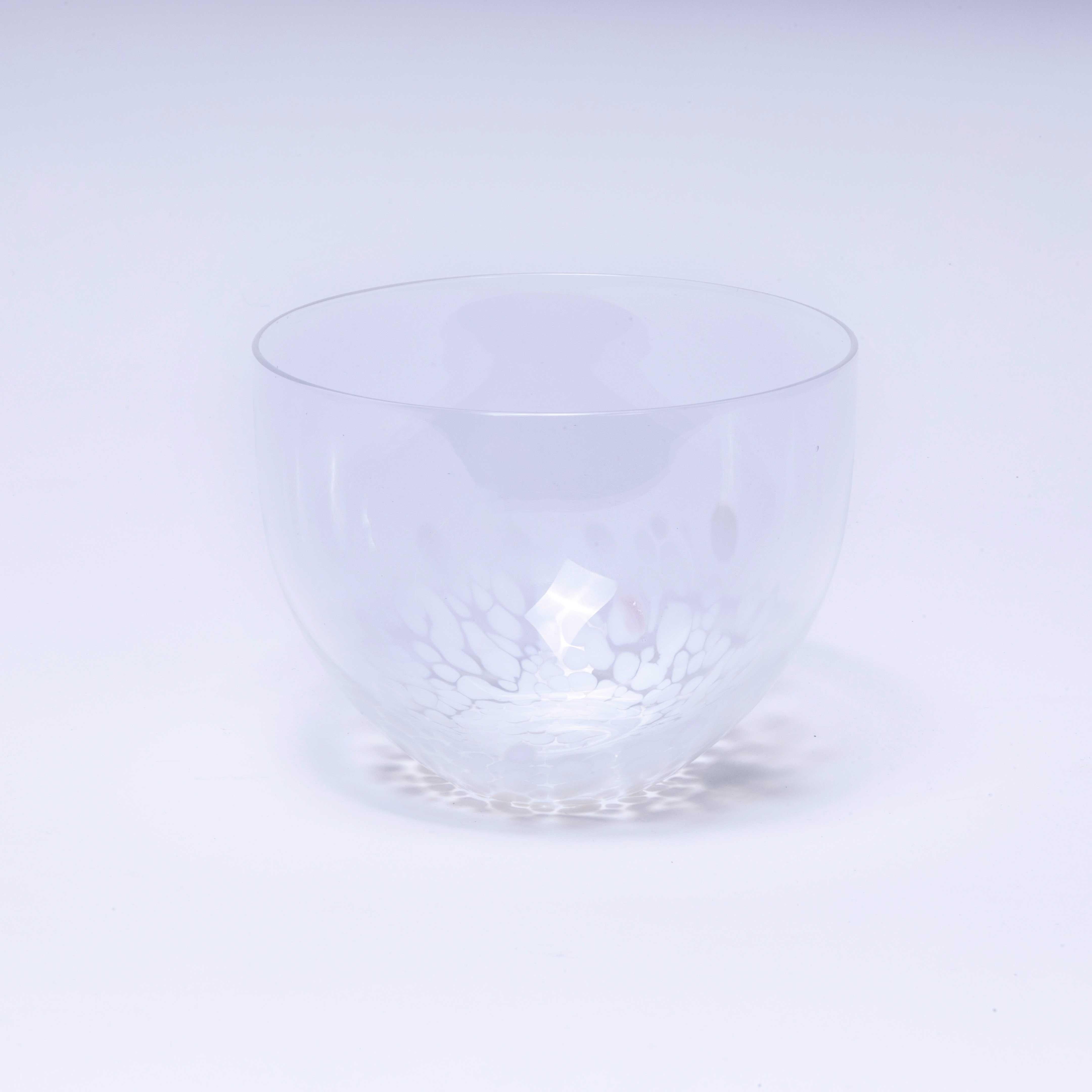Mid Century Mottled Goto Glass Bowl. 

Small art glass bowl made in Sweden using the traditional Murano Goto technique. The molten clear glass orb is hot rolled onto scattered white chips of glass forming the white mottled glass pattern.

Workshop