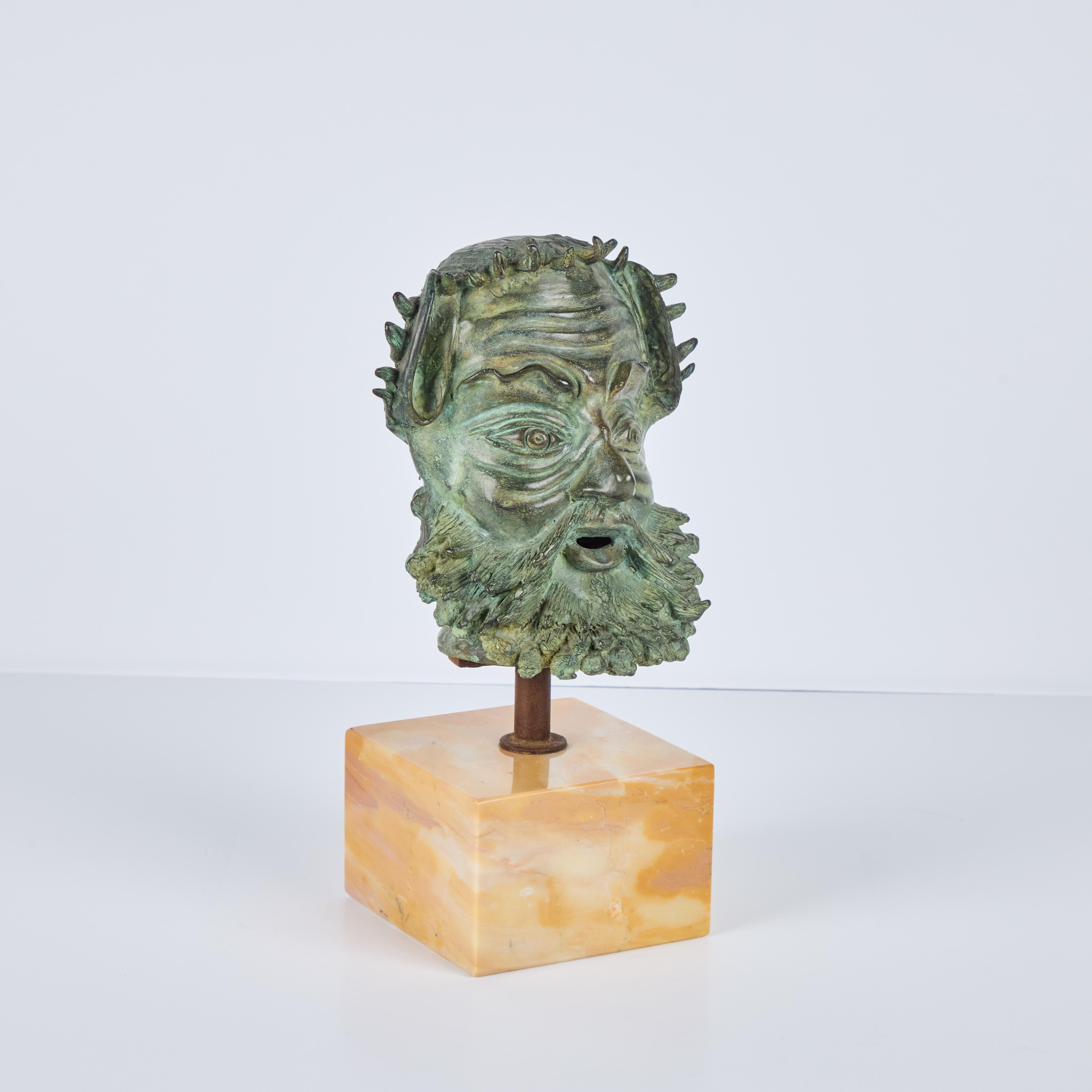 Mid-century , patinated, cast, solid bronze bust of a Greek God mounted on a polished marble base.