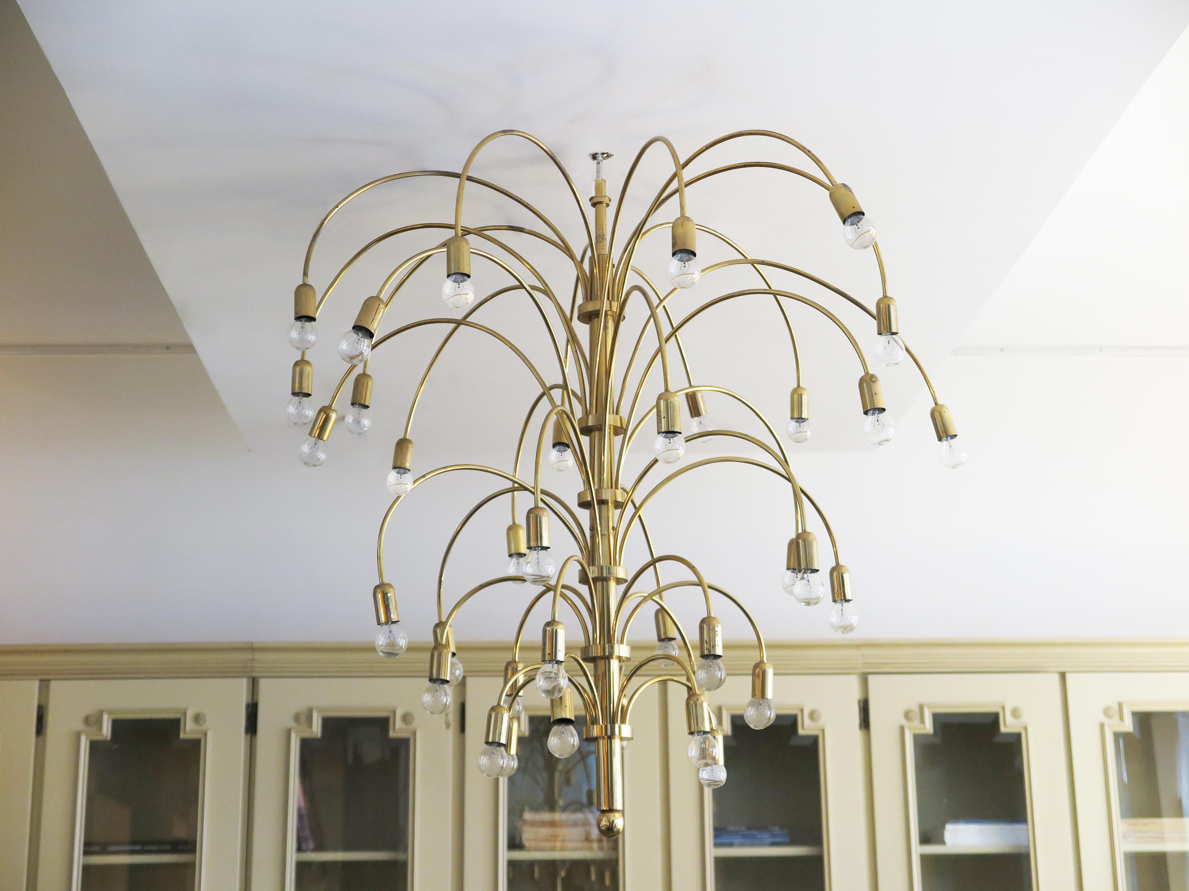 French Mid-Century brass chandelier with lights bursting from the center stem like a firework. This beautiful chandelier holds 36 globe bulbs that sporadically tier down. (Any candelabra base bulb can be used).