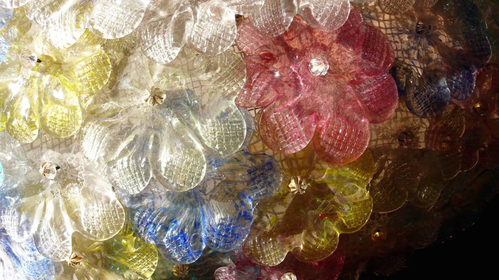 This amazing flower basket is made of dozen of precious Murano flowers glasses. Pink , Yellow , Blu , Light blu  and  Ice color handblown flowers.
 Available a pair and also a pair of extraordinary sconces.
Six E 14 light bulbs  with 4 Watt lights.
 